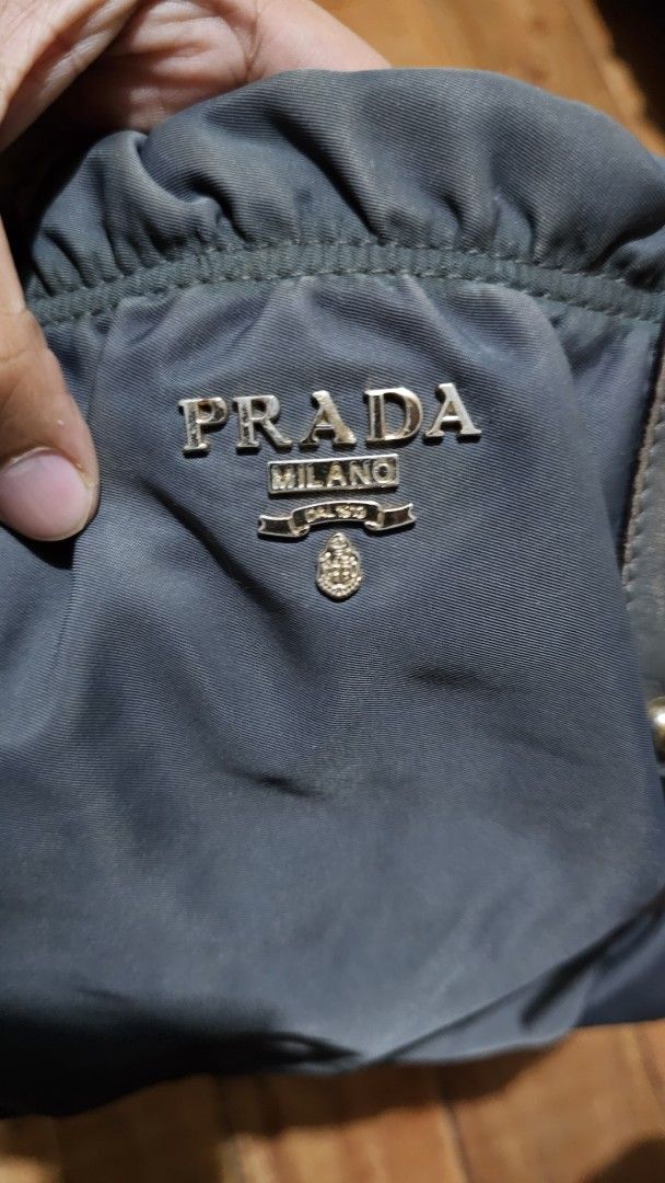 Prada Tessuto Nylon Handbag with Leather Trim (Category: Luxury Bags & Wallets) located in Kibawe. Submitted by Thrift_ni_Babac (Listing ID 1443613832, Image 3). Description: - Prada bag - Color: Black nylon with leather accents - Hardware: Gold - Features: Top handles and detachable shoulder strap - Zipper: Works smoothly - Style: Classic Prada piece See last two photo for issue and Sign of usage.