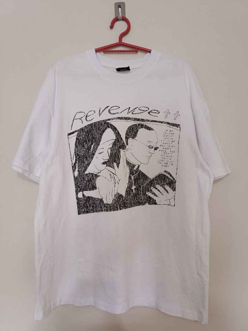 Revenge "Heavent Sent" Graphic Tee (Category: Tshirts & Polo Shirts ) located in Quezon City. Submitted by david.majarucon (Listing ID 1443625658, Image 1). Description: an authentic Revenge "Heaven Sent" Tee in parchment (White), size Medium. Features the brand's signature dark streetwear aesthetic with a detailed, sketch-style black graphic of a nun and a priest. Printed on premium, heavyweight cotton for a perfect modern fit. 21 x 28.