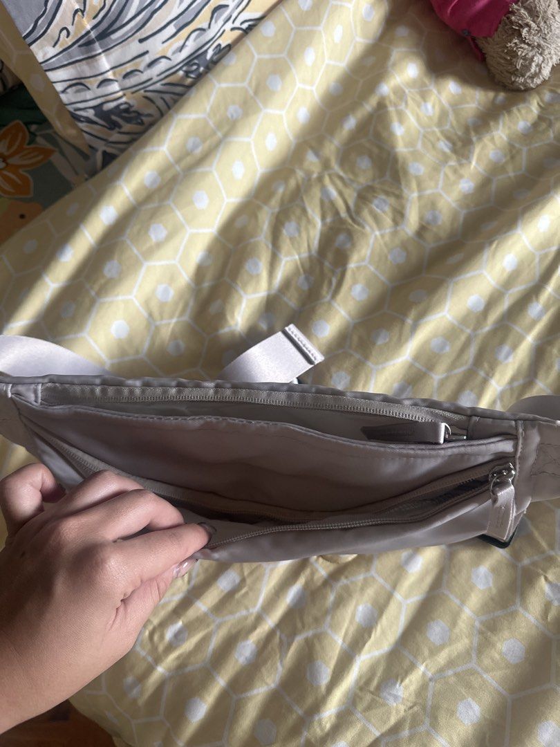 SET Active Fanny Pack Belt Bag (Category: Cross-body Bags) located in Muntinlupa City. Submitted by stuffbya (Listing ID 1443517943, Image 2). Description: NEVER USED Brand: SET - Color: Grey - Material: Nylon - Features: Main zippered compartment, inner pocket - Strap: Adjustable with buckle closure - Versatile: Wearable around the waist or across the body - Functionality: Ideal for keeping essentials easily accessible.