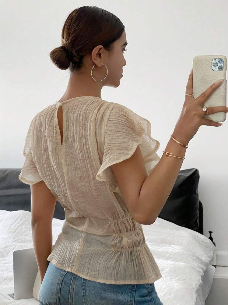 Sheer Textured Peplum Top with Ruffle Sleeves (Category: Blouses) located in Manila. Submitted by loved_ag (Listing ID 1443528573, Image 2). Description: - Lightweight sheer top - Textured crinkle fabric - Flattering ruched waist - Delicate ruffle sleeves - Keyhole closure at the back - Perfect with jeans or skirts - Easy to dress up or down.