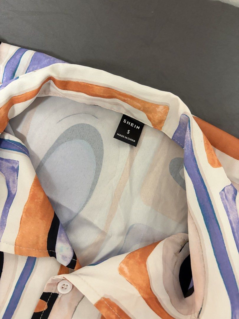 SHEIN Abstract Print Button-Up Shirt Size S (Category: Shirts) located in Pasay City. Submitted by losient (Listing ID 1443664195, Image 2). Description: - SHEIN abstract print button-up shirt - Short sleeves, collared neckline - Unique pattern with orange, purple, and black shapes - Ideal for a casual, statement outfit - Easy to pair with jeans or shorts.