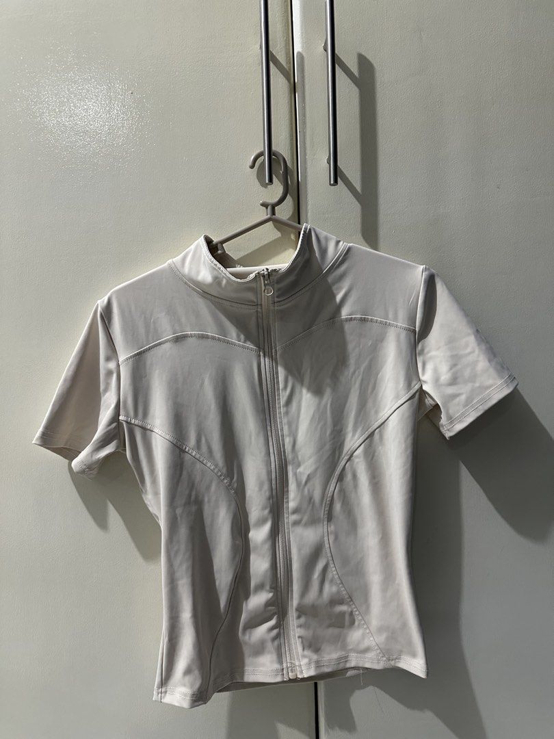 Short Sleeve Zip-Up Mock Neck Activewear Top (Category: Activewear) located in Manila. Submitted by loved_ag (Listing ID 1443556467, Image 3). Description: - Lightweight short sleeve top - Mock neck with full zip closure - Contoured seams for a flattering fit - Ideal for workouts or layering - Comfortable and breathable fabric - Perfect for an active lifestyle.