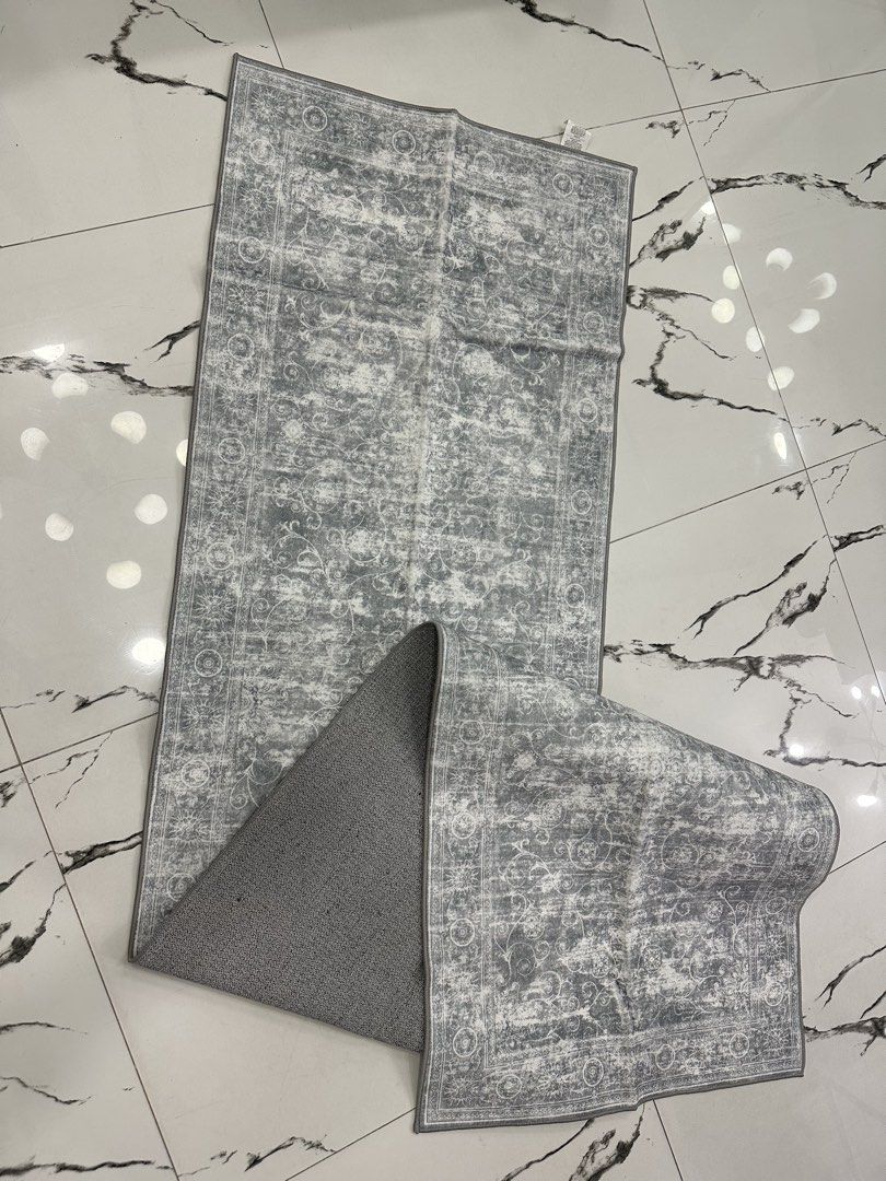 SunNewt Grey Oriental Pattern Rug “Runner” (Category: Carpets, Mats & Flooring) located in Caloocan City. Submitted by janine2006 (Listing ID 1443571889, Image 2). Description: - Stylish grey rug with an oriental-inspired design. - Features a soft surface for comfort. - High-density felt backing for durability. - Initial slight odor and creases are normal; recommend airing out and laying flat for a few days. - Place on a clean, dry floor and ensu