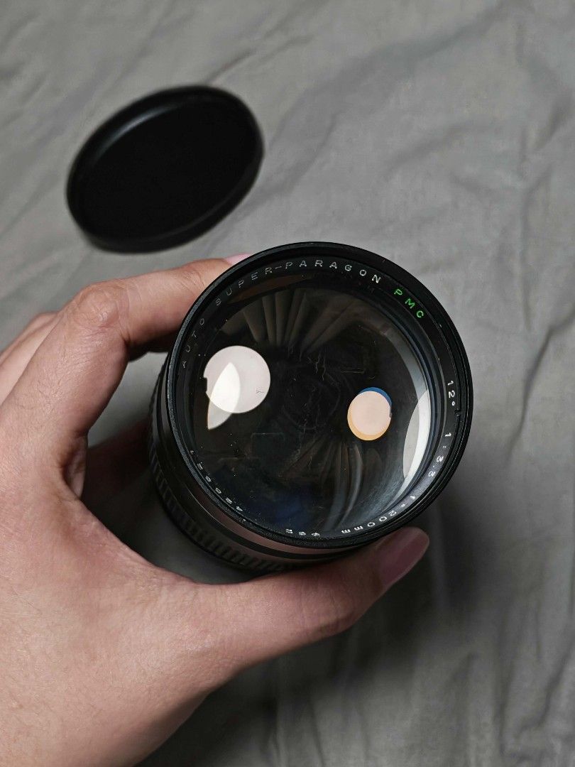 Super Paragon 200mm PMC ( Budget 200m) (Category: Cameras) located in Manila. Submitted by rgr.ink (Listing ID 1443576134, Image 2). Description: - Super Paragon 12x MC zoom lens Budget 200m lens - Versatile focal length: 70mm to 210mm - Clearly marked aperture settings - Smooth focus and zoom rings - Lens cap included - Ideal for various photography needs qc area lala move/jnt/lbc buyer shoulders shipping fee.