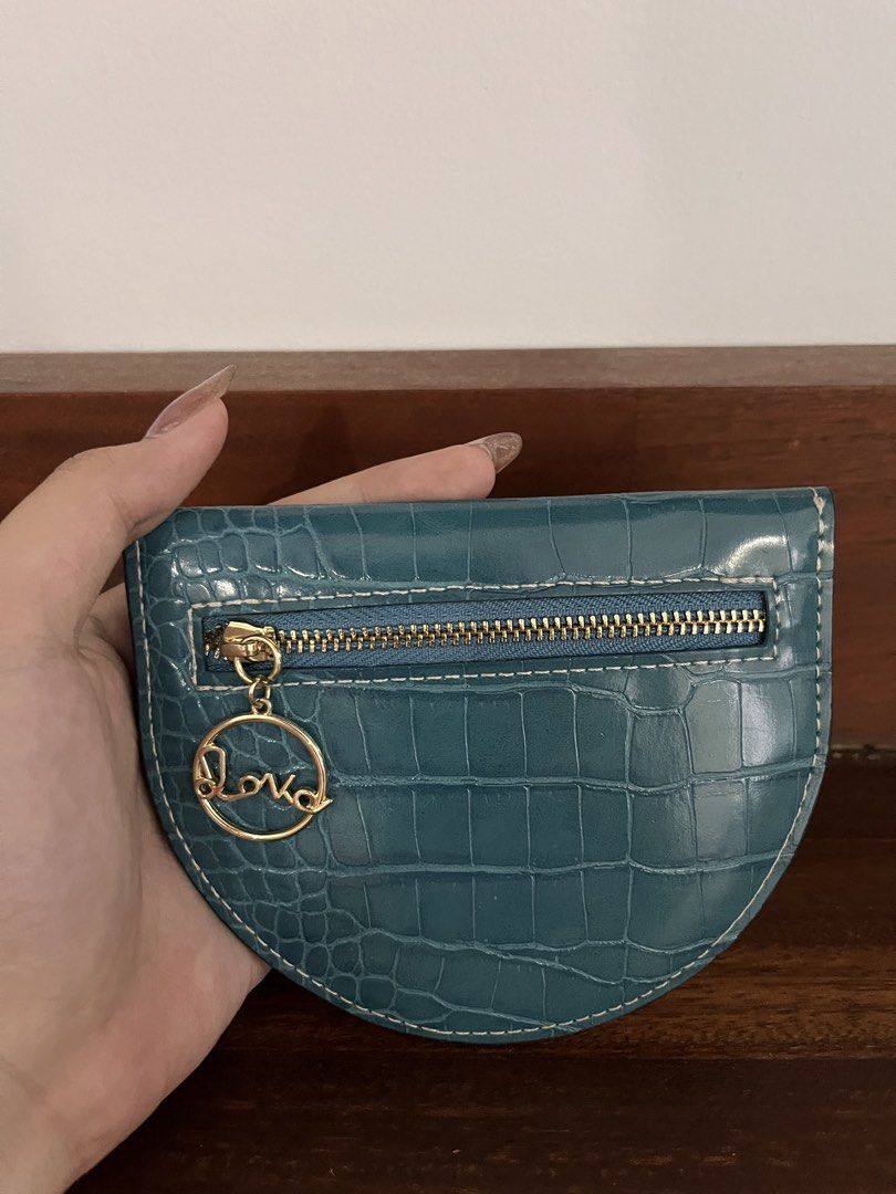 Teal Croc Embossed Wallet with Zipper and Charm (Category: Wallets & Card holders) located in Muntinlupa City. Submitted by ferndez (Listing ID 1443599642, Image 2). Description: - Adorable teal coin pouch - Embossed crocodile texture - Front zippered pocket with a gold 'love' charm - Interior card slots - Two small pouch compartments inside - Ideal for organizing small essentials MOP: GCash.