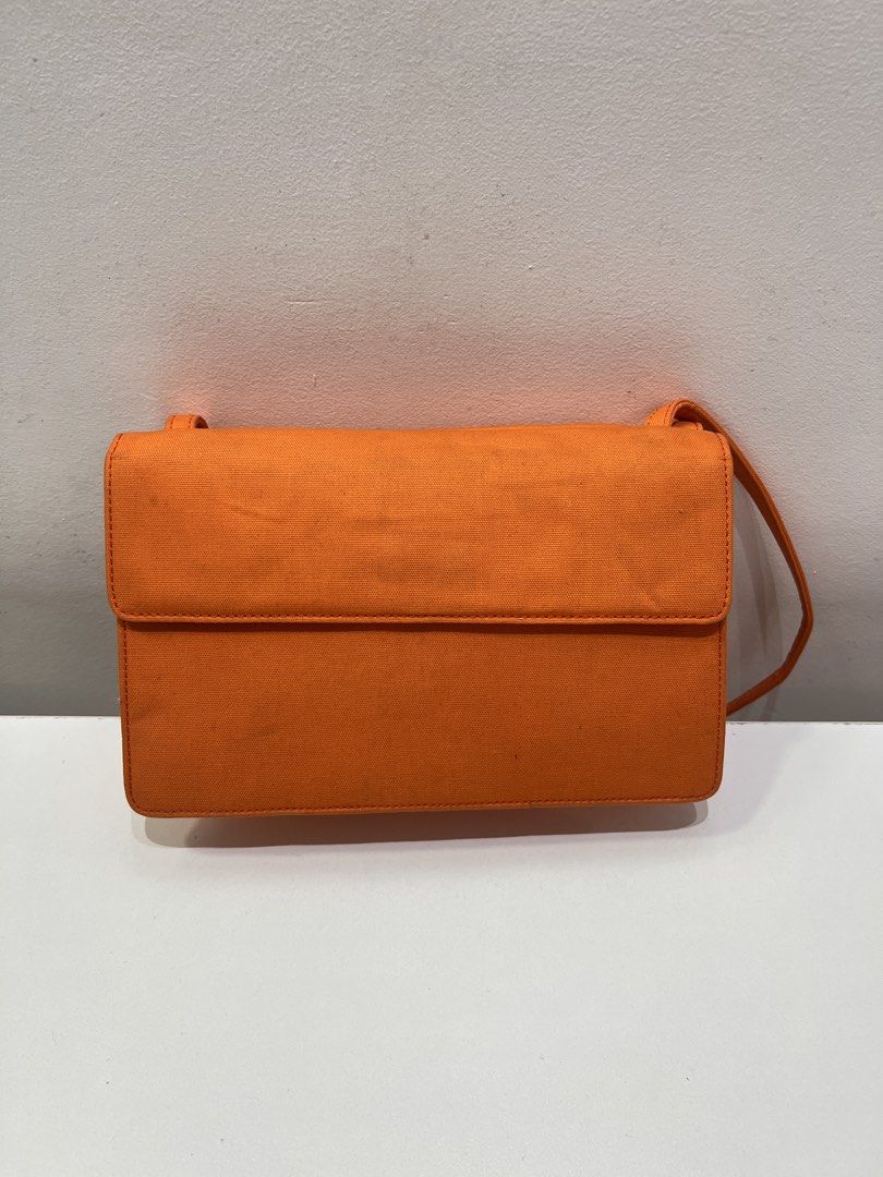 Vintage YSL Sling Bag (Category: Luxury Bags & Wallets) located in Cebu City. Submitted by brandedcorner_ph (Listing ID 1443694863, Image 2). Description: Pre-loved Vntage ((Y))((S))((L ))Sling Bag 100% Authentic or money back Condition • Excellent condition • No flaws • Minimal sign of usage only Product Details •Color:Orange •Hardware: Gold tone •Material: Canvas •Approximate Dimensions in inches: H5.5 x W8.5 x D3.5 Color may vary due to lighti