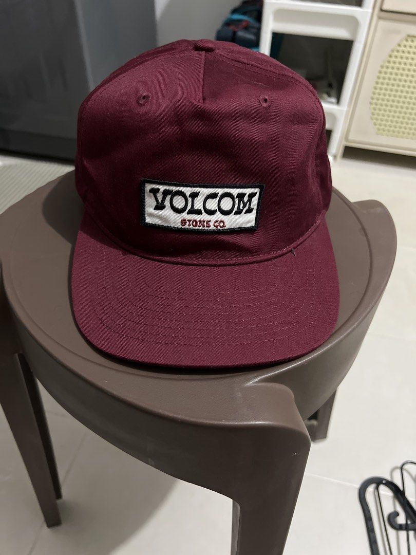 Volcom cap (Category: Caps & Hats) located in Singapore. Submitted by user63222 (Listing ID 1443694621, Image 1). Description: - Burgundy Volcom cap - Features Volcom Tones Co. logo patch on front - Adjustable snapback closure - Classic baseball cap style - Suitable for everyday wear.