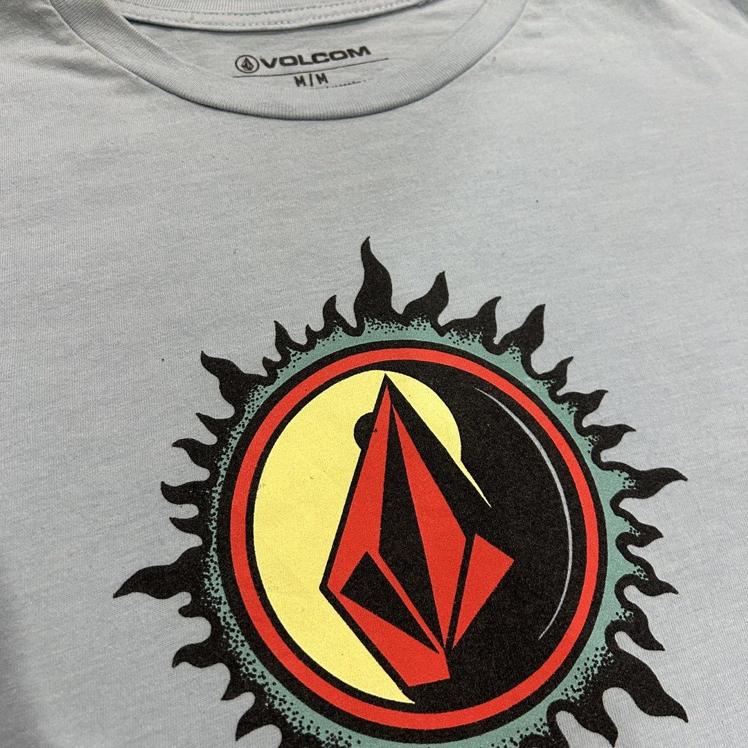 Volcom T-Shirt M/M Blue Graphic Tee (Category: Tshirts & Polo Shirts ) located in General Santos City (Dadiangas). Submitted by bosz_thirftgsc (Listing ID 1443575208, Image 3). Description: - Light blue Volcom t-shirt - Features iconic Volcom stone logo within a sun graphic - Size: Medium (M) - Material: 50% Cotton, 50% Polyester - Ideal for casual wear -18x26 -No Issue.