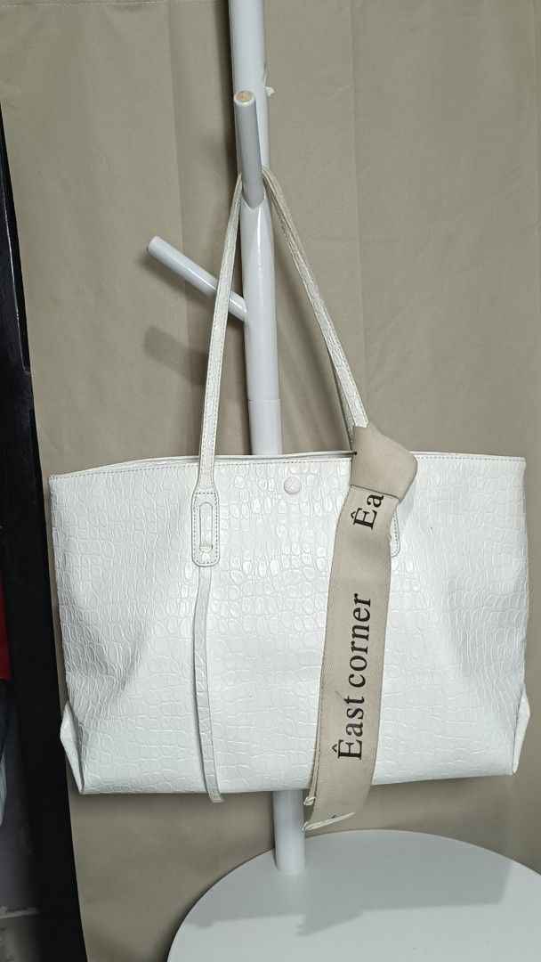 White Crocodile Embossed Tote Bag with "East Corner" Strap (Category: Tote Bags) located in Antipolo. Submitted by secondmusebags (Listing ID 1443663665, Image 2). Description: We sell authentic preloved bags 😊 Condition: Good as new with minimal signs of usage Can send more photos or vids of the bag Price is negotiable for 2 bags and up Tiktok: secondmusebags Location: Upper Antipolo Available for meetup Delivery: Lalamove or J&T - White tote b