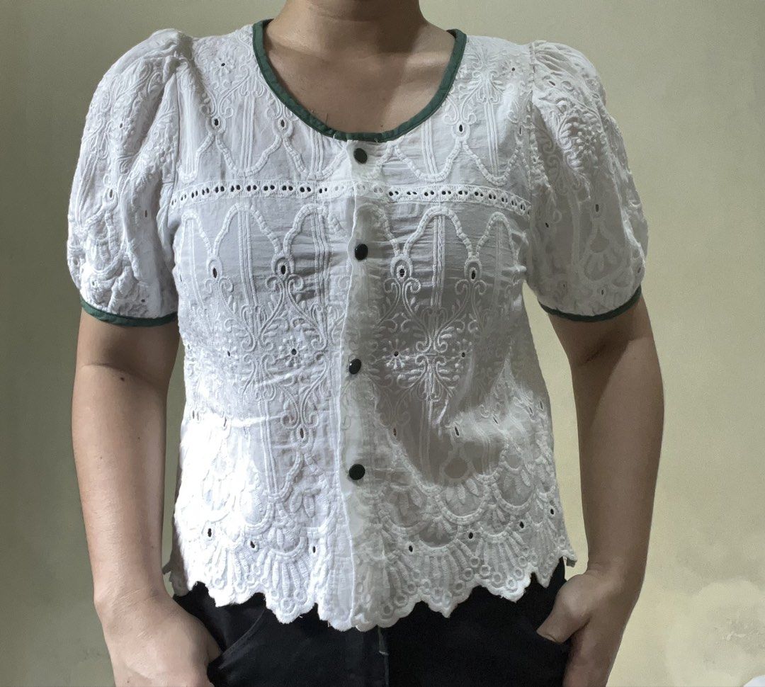 ST33 White Embroidered Blouse with Green Trim (Category: Blouses) located in Marikina City. Submitted by namicorner (Listing ID 1439634408, Image 3). Description: - White blouse with delicate embroidery - Features a scalloped hem - Short, puffy sleeves - Round neckline with green trim - Button-down front - Lightweight fabric, ideal for warm weather - Versatile style: dress it up or down.