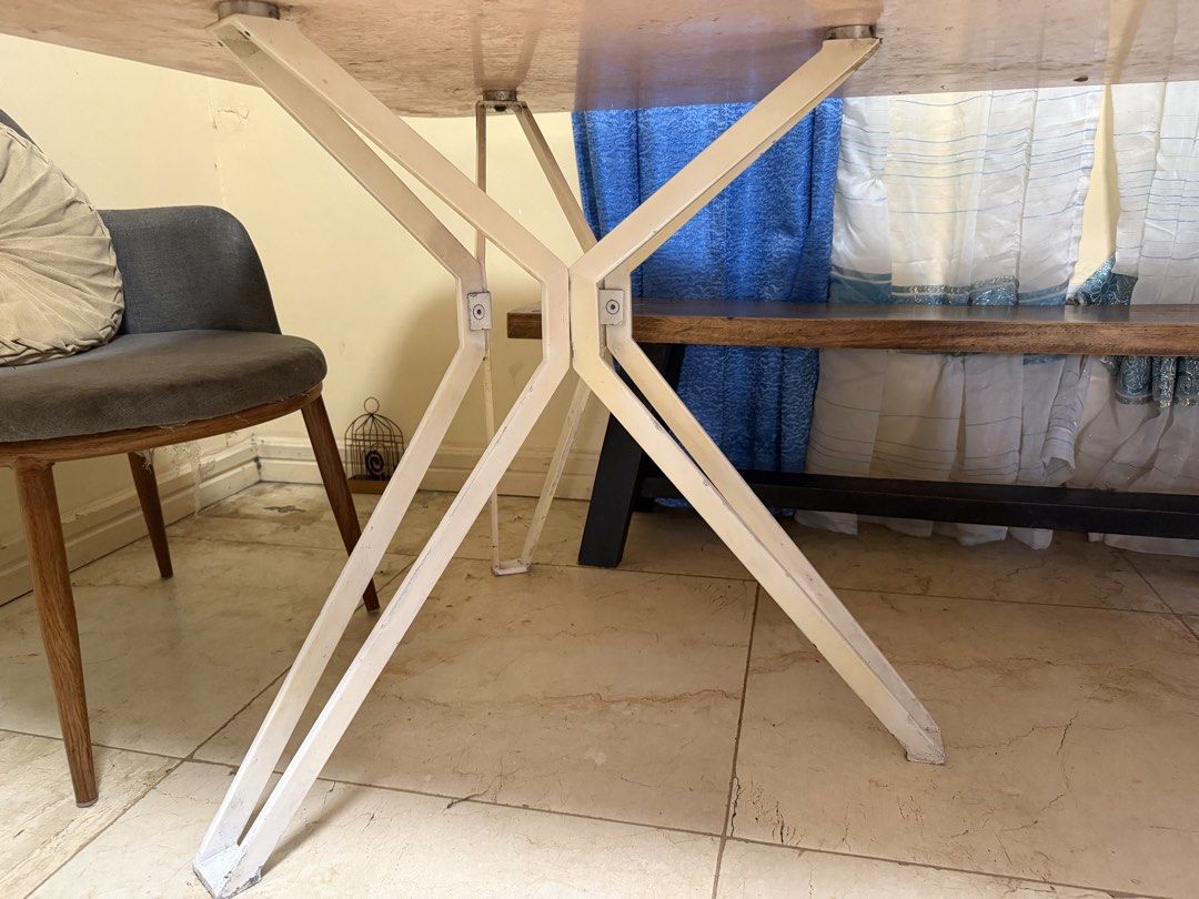 White Glass Top Dining Table with Unique Metal Legs (Category: Tables & Sets) located in Cainta. Submitted by jtc23 (Listing ID 1443660893, Image 3). Description: - Sleek modern dining table - Smooth white glass top - Distinctive white metal base with criss-cross legs - Spacious design, ideal for dining rooms or as a large desk - Easy to clean surface - Perfect for gatherings and work sessions.