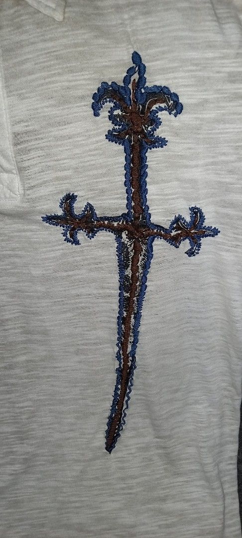 White Polo Shirt with Sword Embroidery (Category: Tshirts & Polo Shirts ) located in Cagayan de Oro. Submitted by edwardryan01984 (Listing ID 1443661314, Image 3). Description: - White short-sleeved polo shirt - Features a unique sword embroidery on the chest - Textured fabric for a premium feel - Classic button-up neckline - Ideal for casual outings and everyday style.