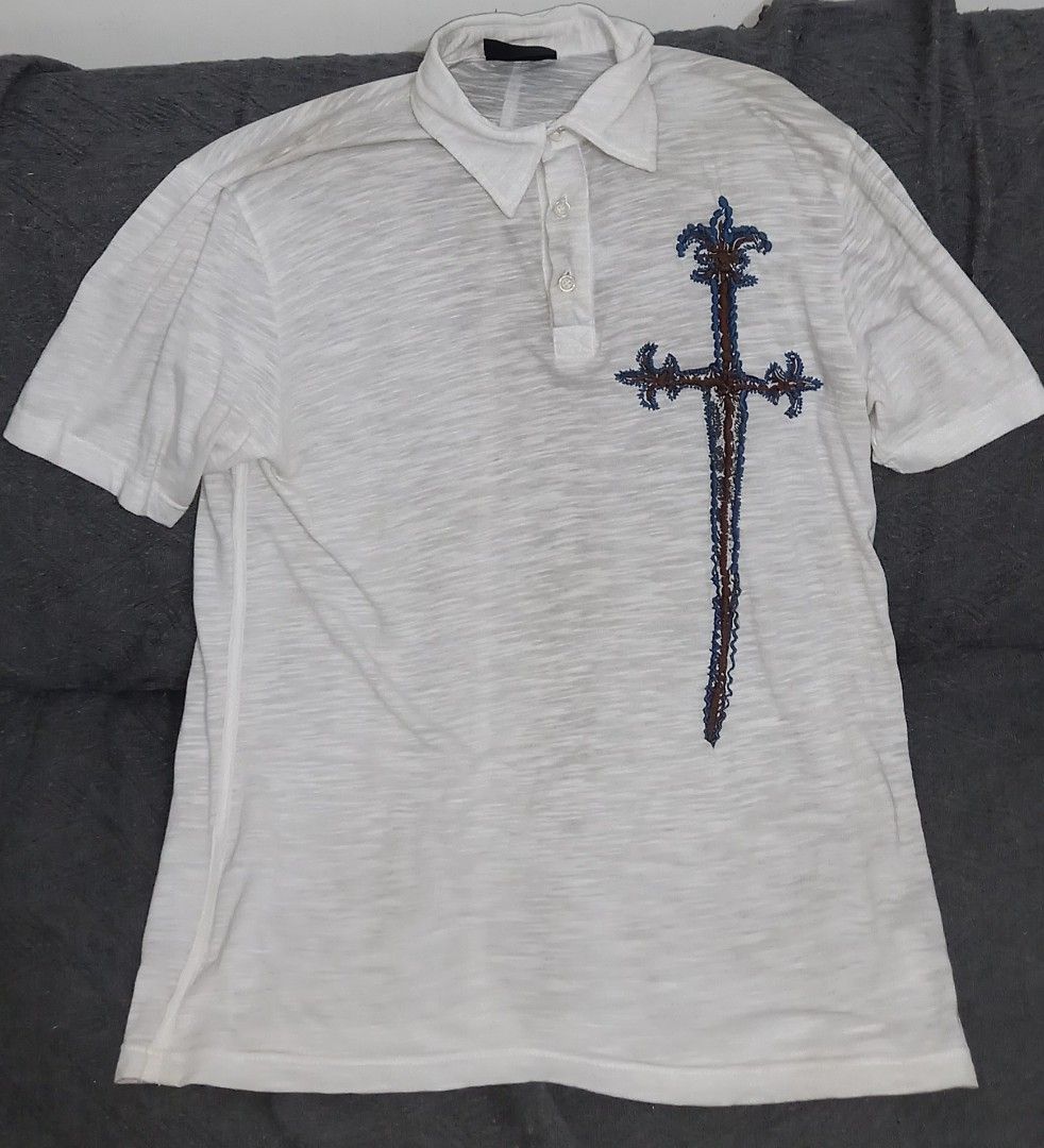 White Polo Shirt with Sword Embroidery (Category: Tshirts & Polo Shirts ) located in Cagayan de Oro. Submitted by edwardryan01984 (Listing ID 1443661314, Image 1). Description: - White short-sleeved polo shirt - Features a unique sword embroidery on the chest - Textured fabric for a premium feel - Classic button-up neckline - Ideal for casual outings and everyday style.