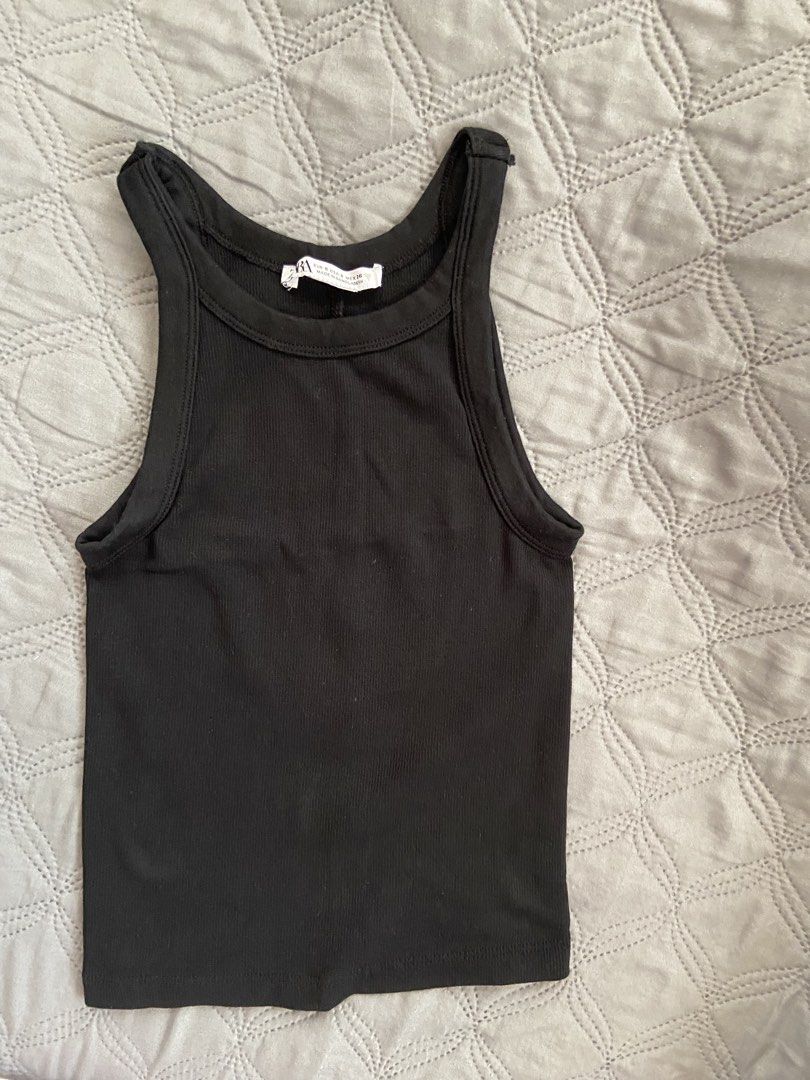 Zara Black Ribbed Racerback Tank Top (Category: Sleeveless) located in Mandaluyong City. Submitted by decluttermyitems (Listing ID 1443535357, Image 1). Description: - Basic black ribbed tank top from Zara - Racerback style - Stretchy material for a comfortable fit - Versatile staple piece, great for layering or wearing on its own.