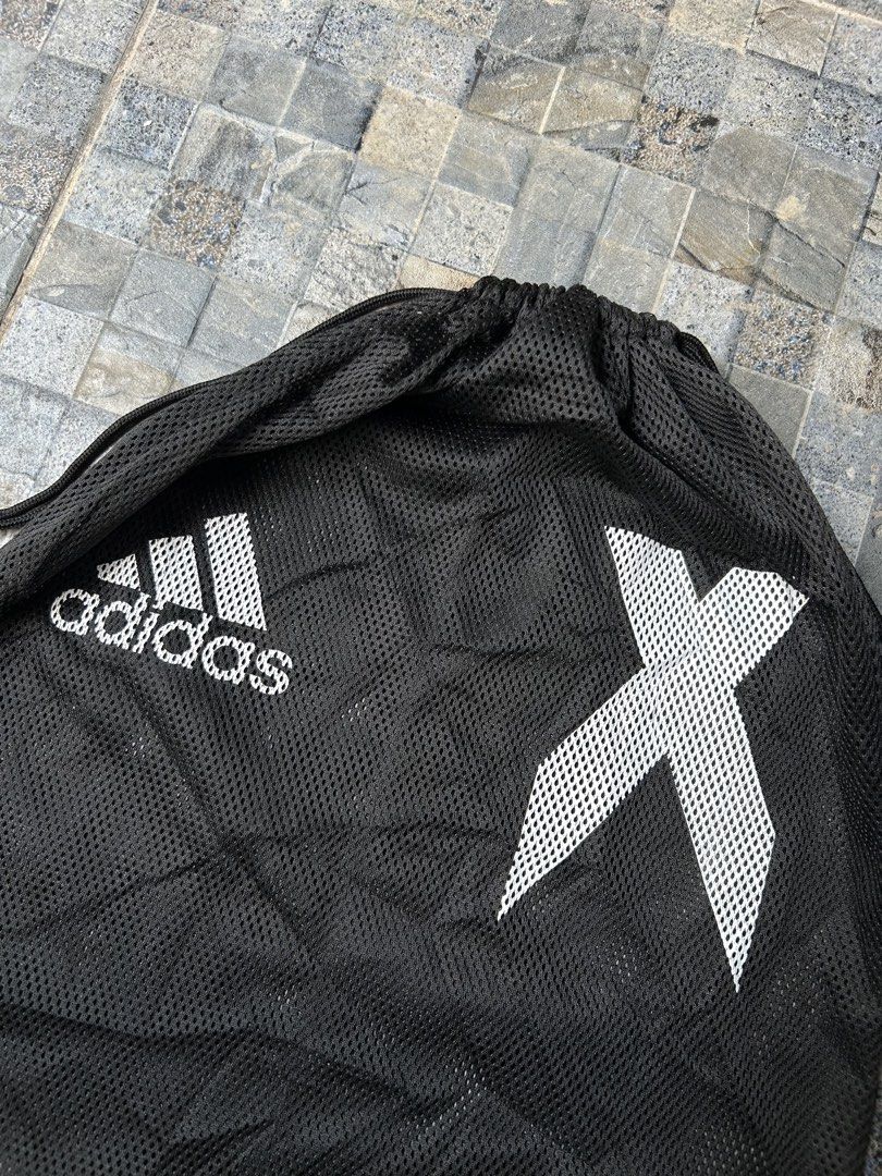 Adidas Black Drawstring Bag with X Logo (Category: Backpacks) located in Quezon City. Submitted by commonwealthpickerph (Listing ID 1443765795, Image 3). Description: Black Adidas drawstring bag - 14.5 width // 16 length - Features iconic Adidas logo and white X graphic - Made of breathable mesh material - Note: Color may wear off with use over time - Ideal for gym, sports, or everyday essentials.