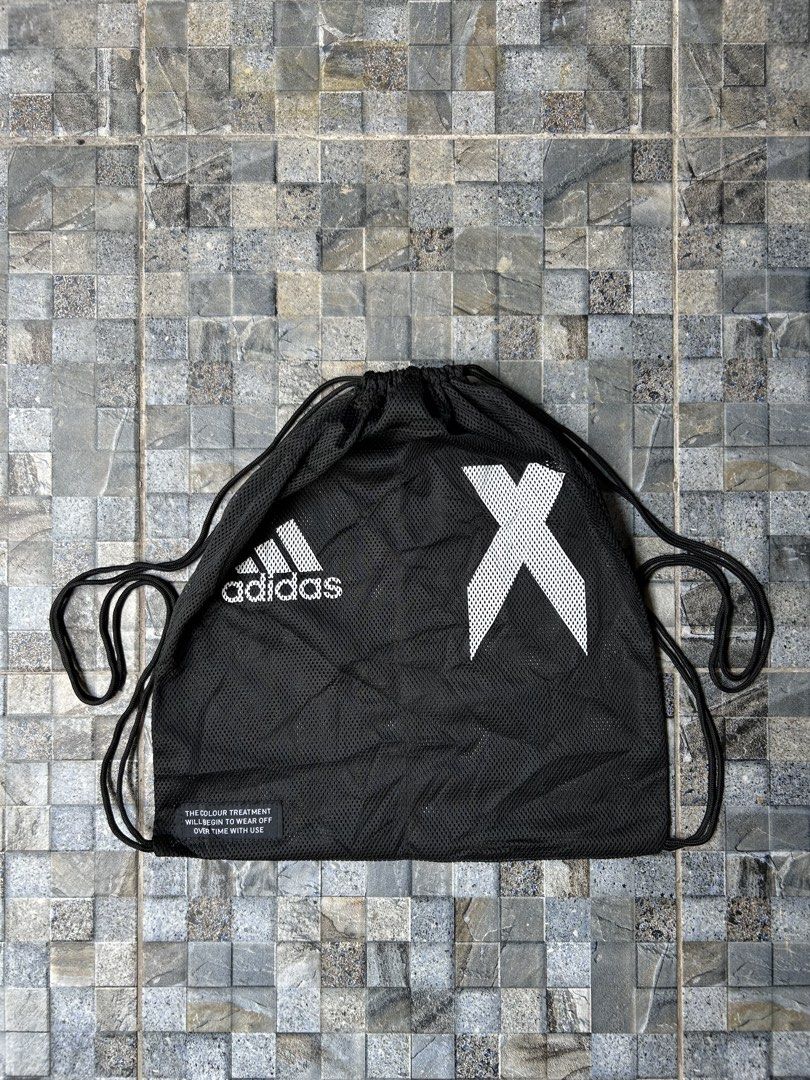 Adidas Black Drawstring Bag with X Logo (Category: Backpacks) located in Quezon City. Submitted by commonwealthpickerph (Listing ID 1443765795, Image 1). Description: Black Adidas drawstring bag - 14.5 width // 16 length - Features iconic Adidas logo and white X graphic - Made of breathable mesh material - Note: Color may wear off with use over time - Ideal for gym, sports, or everyday essentials.