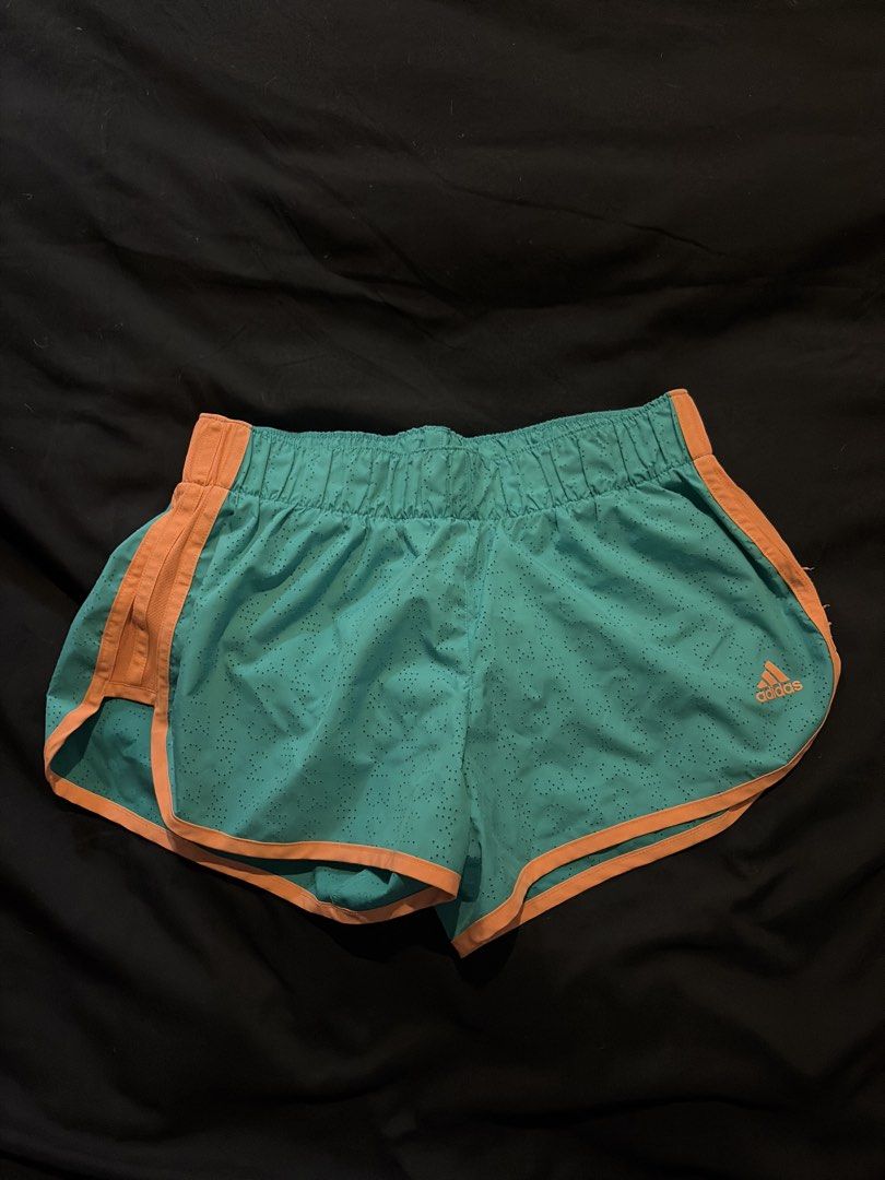 Adidas Climalite Teal Orange Running Shorts (Category: Activewear) located in Quezon City. Submitted by shopsoph (Listing ID 1443761396, Image 1). Description: - Teal running shorts with vibrant orange trim. - Perforated fabric for maximum breathability during workouts. - Comfortable elastic waistband for a secure fit and double lined - Iconic Adidas logo featured on the side. - RFS: hand me down from my cousin but not my style.