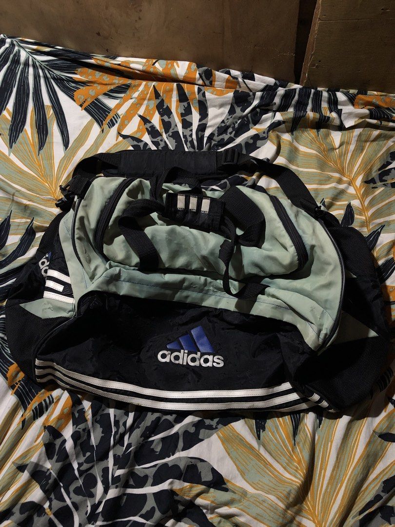 Adidas Duffle Bag / Backpack (Category: Backpacks) located in Manila. Submitted by bakithrift213 (Listing ID 1443839109, Image 2). Description: - Vintage Adidas duffle bag that converts to a backpack - Classic Adidas stripes and logo - Colorway: Black, mint green, and white - Perfect size for gym sessions or short trips - Shows some signs of wear, but fully functional.