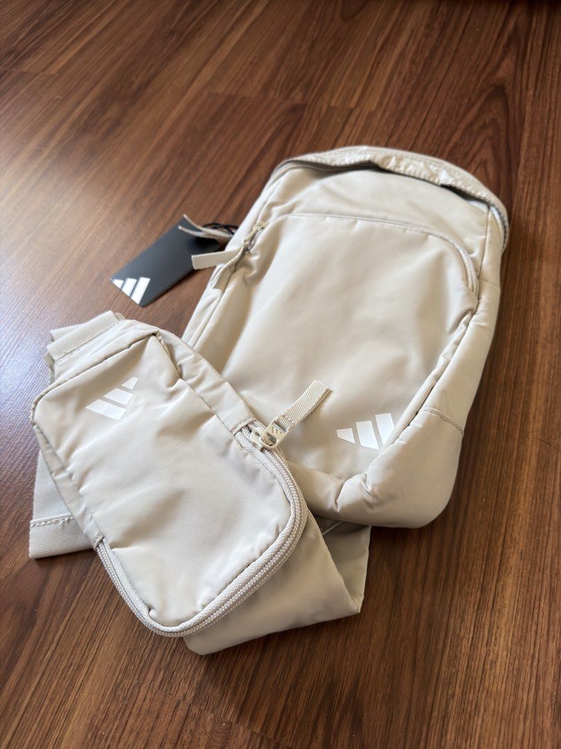 Adidas Sling Bag w/ Pouch (Category: Sling Bags) located in Antipolo. Submitted by kzees (Listing ID 1443805947, Image 2). Description: - Original - Brandnew w/ tag - Adidas sling bag and pouch set - Color: Alumina Grey/White - Sling bag features: Main compartment, internal mesh pocket, front zip pocket - Pouch features: Smaller zip-around style - Both items have the Adidas logo - Ideal for everyday use or travel.