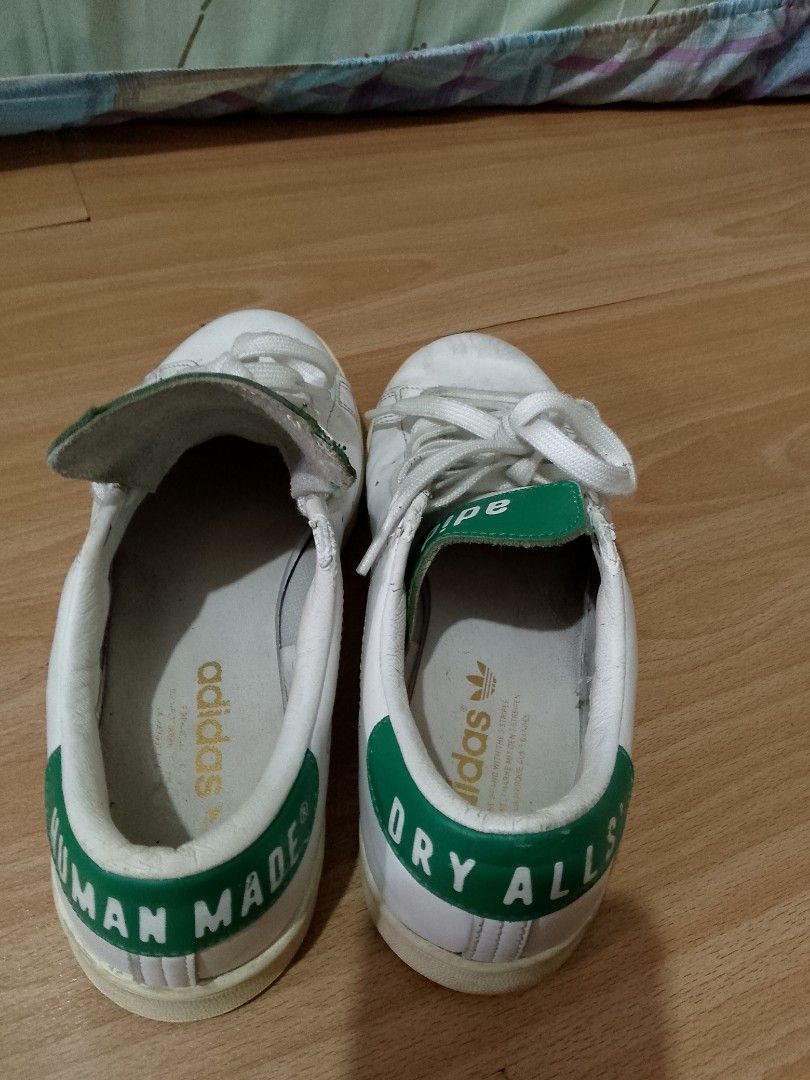 Adidas x Human Made Stan Smith Sneakers (Category: Sneakers) located in Pasig City. Submitted by lucy033025 (Listing ID 1443749256, Image 2). Description: - Adidas Stan Smith x Human Made collaboration - White leather with green accents - Features iconic Human Made heart logo - 'DRY ALLS' text on heel - White laces - Soles show some wear - Size: 40 EU.