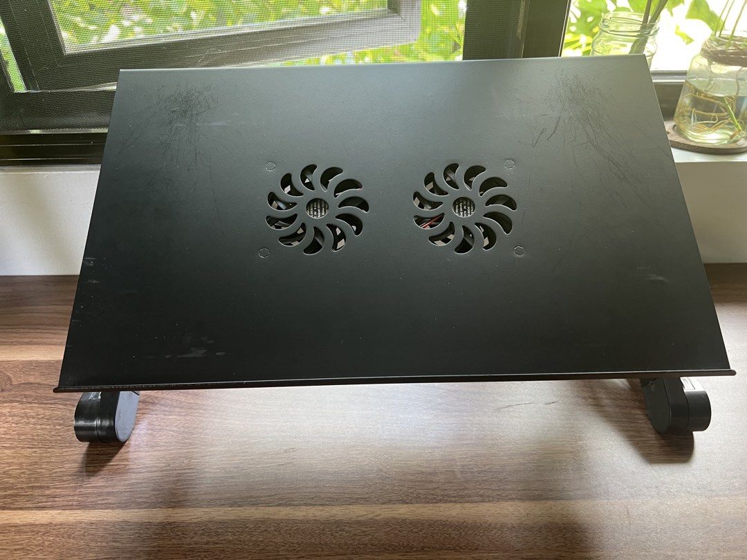 Adjustable Black Laptop Stand (Category: Laptop Bags & Sleeves) located in Manila. Submitted by migsvillanueva (Listing ID 1443745430, Image 2). Description: - Black laptop stand with 2 built-in cooling fans - Adjustable legs for height and angle - Enhances laptop airflow and user ergonomics - Folds flat for easy storage and portability - Ideal for home and office use.