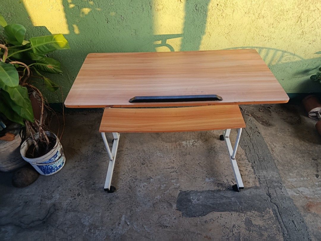 Adjustable Laptop Table with Wheels and Shelf (Category: Tables & Sets) located in Quezon City. Submitted by truephoenix.16cee3 (Listing ID 1443810107, Image 3). Description: - Adjustable height for comfortable use - Built-in shelf for extra storage - Rolls on wheels for easy mobility - Tilting tabletop for optimal viewing angle - Ideal for working from home or studying - Simple and functional design Manual measurements : Length: 80cm Width : 40c