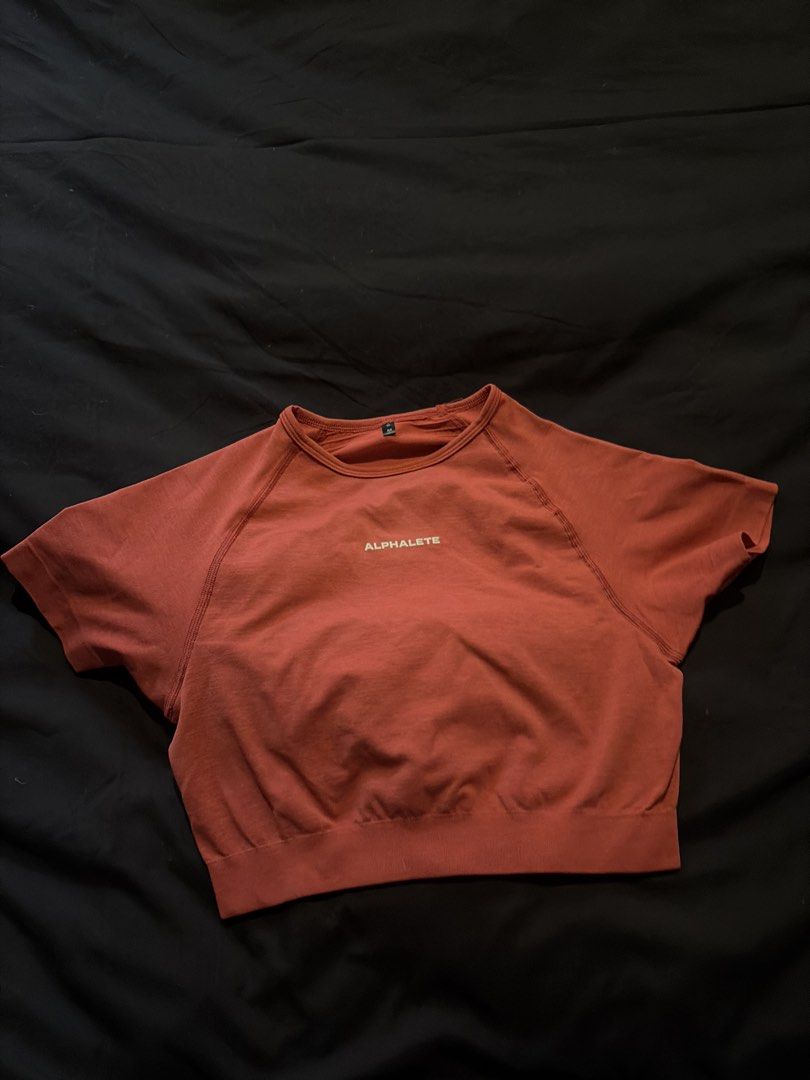Alphalete Cropped Seamless Short Sleeve Top (Category: Others Tops) located in Quezon City. Submitted by shopsoph (Listing ID 1443760508, Image 1). Description: - Alphaelete cropped top - Short sleeves with raglan design - Made with seamless knit fabric - Beautiful magenta/pink red color - Approximately 15 inches in length (shoulder to hem) - Ideal for workouts or casual wear - RFS: hand me down from my cousin but not my style.