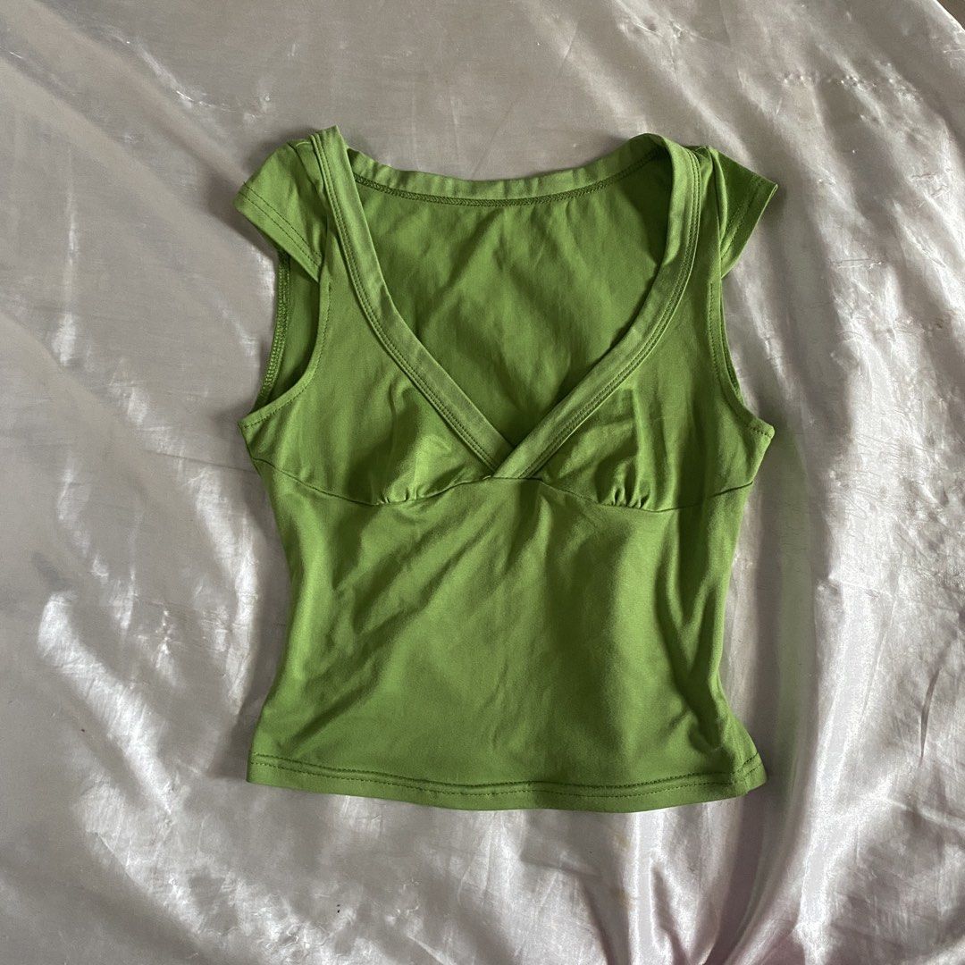 Apple Green V-neck Tank Top y2k (Category: Sleeveless) located in San Juan City. Submitted by adore.me (Listing ID 1443813003, Image 1). Description: - Cute green tank top - V-neck design with gathered bust - Short cap sleeves - Stretchy and comfortable material - Versatile for casual wear or layering - Pairs well with jeans or shorts.
