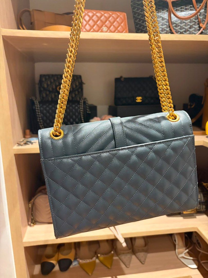 AUTHENTIC YSL Medium Envelope Bag in Gray (Category: Luxury Bags & Wallets) located in Manila. Submitted by preloved_tdc (Listing ID 1443718825, Image 2). Description: Grained leather, Gold Hardware With card and dustbag Can be a shoulder and crossbody bag.