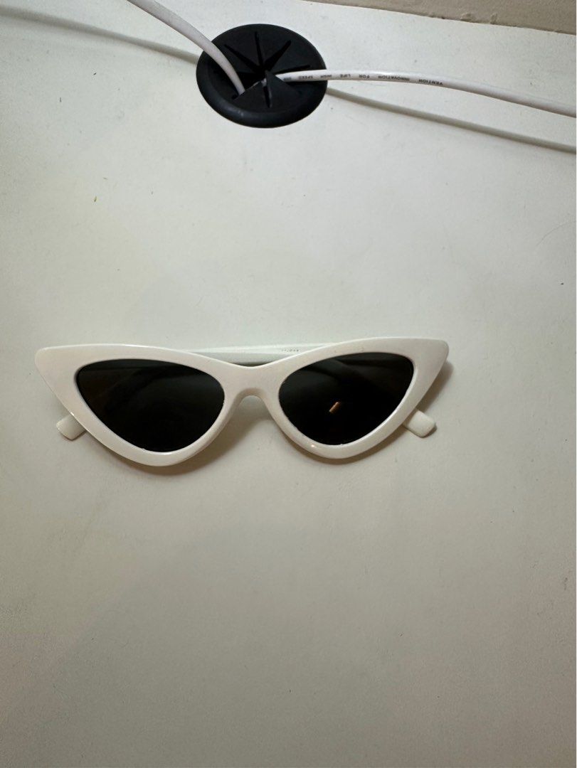 Baobab White Cat-Eye Sunglasses with Case (Category: Sunglasses & Eyewear) located in Taytay. Submitted by barkfactory (Listing ID 1443771527, Image 2). Description: BAOBAB SUNGLASSES - used once/twice - Chic white cat-eye sunglasses - Comes with a cool cylindrical case featuring a colorful abstract design - Case has the 'baobab' logo - Adds flair to any outfit - Ideal for sunny days out.