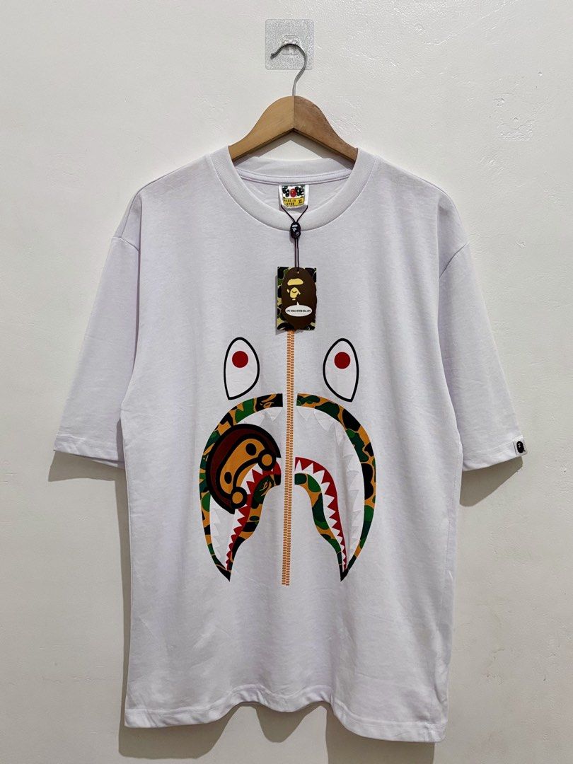 BAPE CAMO MILO SHARK TEE SHIRT (Category: Tshirts & Polo Shirts ) located in Quezon City. Submitted by dasharchive (Listing ID 1443858709, Image 1). Description: • COMPLETE W/ HANGTAGS SIZE: X-LARGE (ON TAG) Can fit up to LARGE EXCELLENT CONDITION 📍 NORTH FAIRVIEW, QUEZON CITY.