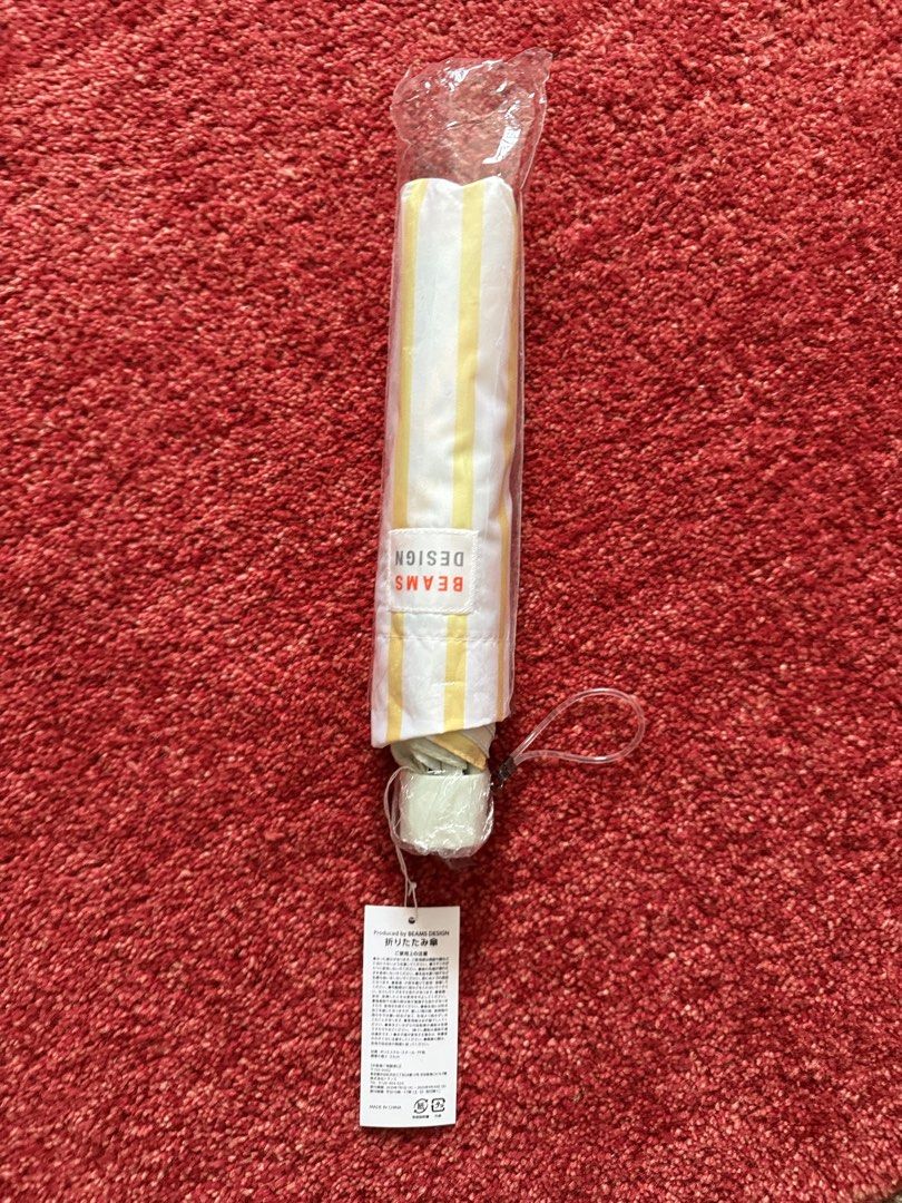 BEAMS DESIGN Striped Folding Umbrella Yellow White (Category: Umbrellas) located in Manila. Submitted by jcbagio20 (Listing ID 1443771494, Image 1). Description: 10 PIECES AVAILABLE!!! - Cute folding umbrella from BEAMS DESIGN - Features a stylish yellow and white stripe pattern - Compact and portable, ideal for on-the-go - Brand new, still in original packaging with tags attached - Perfect size to keep in your bag for unexpected rain.
