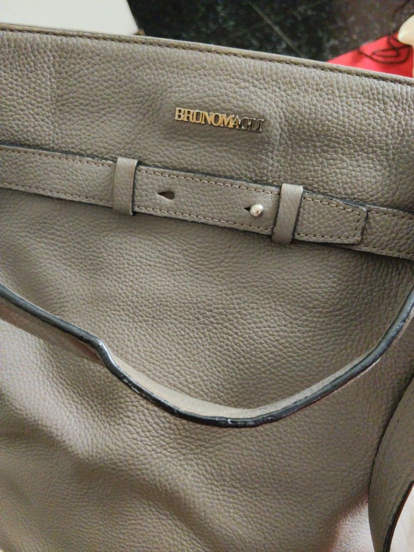 Bruno Magli Grey Leather Bucket Bag (Category: Shoulder Bags) located in Batangas. Submitted by ms.d_preloveditems (Listing ID 1443722212, Image 2). Description: - Authentic Bruno Magli grey leather bucket bag - Textured leather finish - Secure drawstring closure with stylish buckle details - Adjustable shoulder strap for comfortable wear - Interior features the signature Bruno Magli branded stamp - Comes with its original dust bag for protection