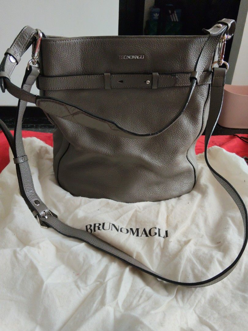 Bruno Magli Grey Leather Bucket Bag (Category: Shoulder Bags) located in Batangas. Submitted by ms.d_preloveditems (Listing ID 1443722212, Image 1). Description: - Authentic Bruno Magli grey leather bucket bag - Textured leather finish - Secure drawstring closure with stylish buckle details - Adjustable shoulder strap for comfortable wear - Interior features the signature Bruno Magli branded stamp - Comes with its original dust bag for protection