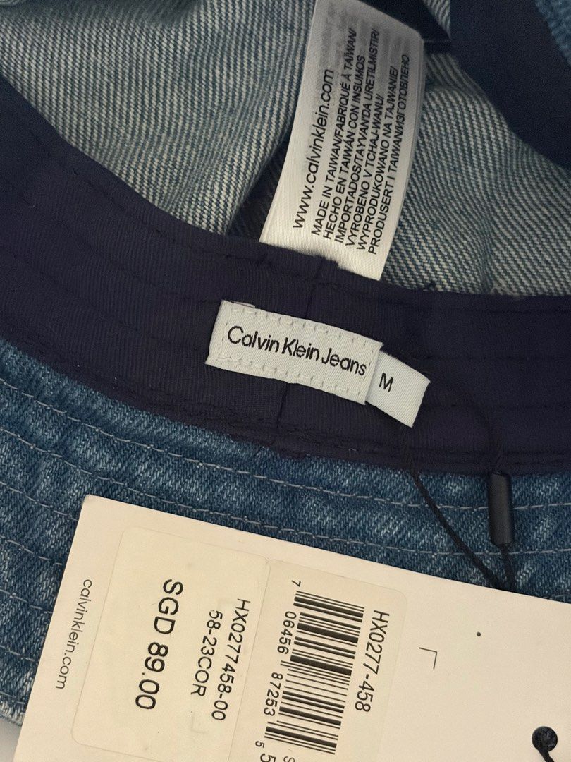 Calvin Klein Jeans Denim Bucket Hat (Category: Hats & Beanies) located in Quezon City. Submitted by rv1995 (Listing ID 1443778722, Image 2). Description: - Classic blue denim bucket hat from Calvin Klein Jeans - Features iconic CK logo embroidered on the front - Size: M - Brand new with original tag still attached - Ideal for sunny days and casual wear Featuring an unmistakable, iconic silhouette, this Calvin Klein bucket hat brings effortless st