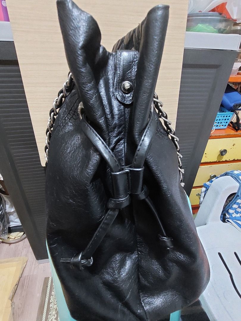 Chanel Black Quilted Leather Drawstring Chain Shoulder Bag (Category: Luxury Bags & Wallets) located in Davao. Submitted by oddlion_769da3 (Listing ID 1443809380, Image 3). Description: - Authentic Black Leather Chanel Bag - Quilted Front with Iconic Green CC Logo - Silver Chain Straps - Convenient Drawstring Closure - Interior Zippered Pocket - Signature Chanel Logo Lining - Made in France.