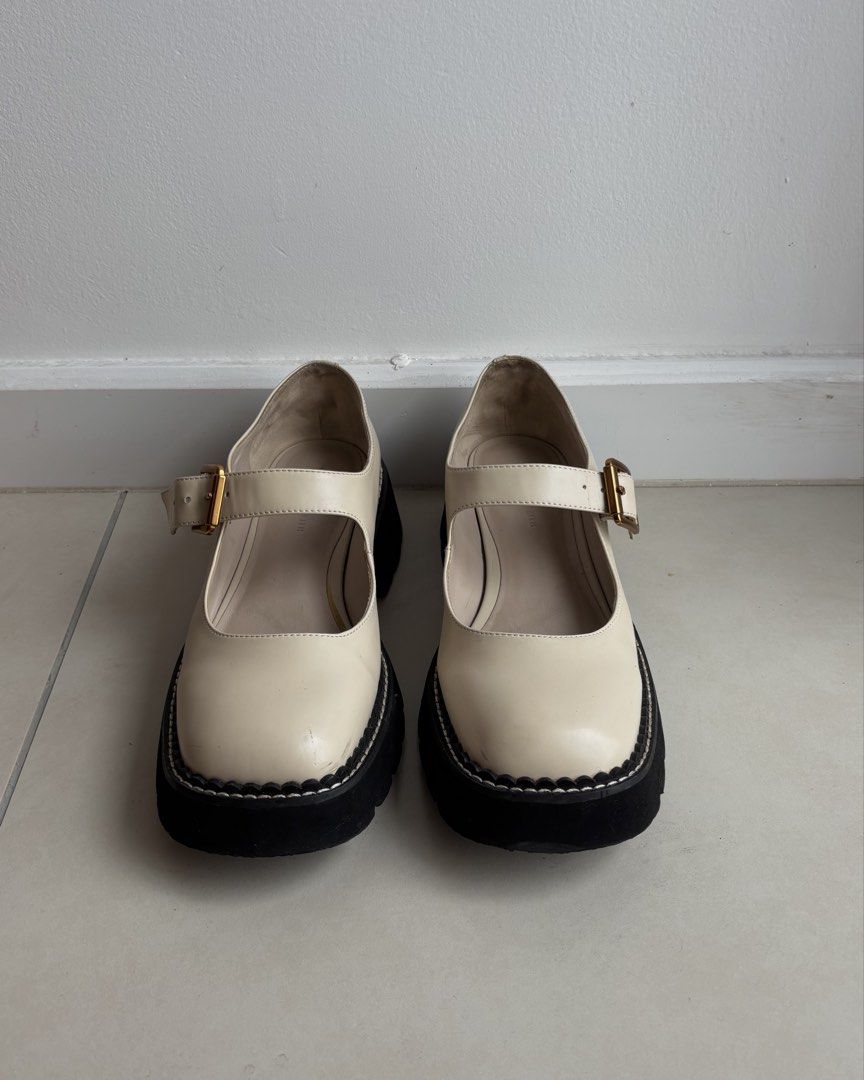 Charles & Keith Cream Mary Jane Platform Shoes (Category: Loafers) located in Cyberjaya. Submitted by loqect (Listing ID 1443750819, Image 2). Description: - Cream Mary Jane platform shoes from Charles & Keith - Features a secure buckle strap across the foot - Chunky black platform sole with stylish white stitching detail - Classic round toe design - Perfect for dressing up or down, adding a trendy touch to any look.