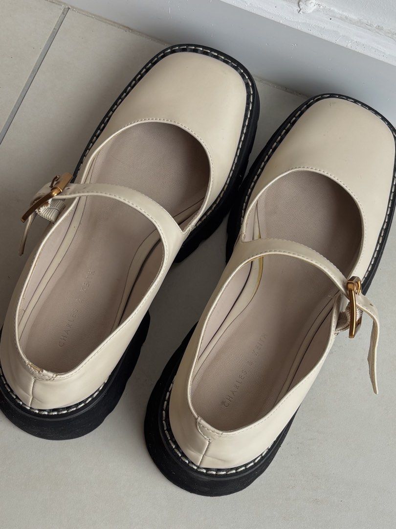 Charles & Keith Cream Mary Jane Platform Shoes (Category: Loafers) located in Cyberjaya. Submitted by loqect (Listing ID 1443750819, Image 1). Description: - Cream Mary Jane platform shoes from Charles & Keith - Features a secure buckle strap across the foot - Chunky black platform sole with stylish white stitching detail - Classic round toe design - Perfect for dressing up or down, adding a trendy touch to any look.