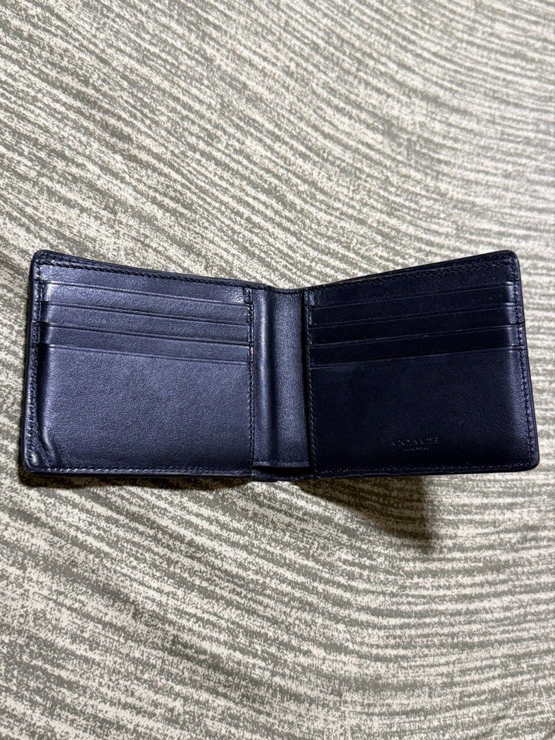 Rush! Coach Embossed Signature Bifold Wallet (Category: Luxury Bags & Wallets) located in Mandaue City. Submitted by kodenameblue (Listing ID 1443806850, Image 2). Description: - Coach Bifold Wallet - Signature embossed C logo all over exterior - Interior with multiple card slots and Bull Compartment - Unit Only no dustbag or receipt included - Clean inside and out - Issues: Signs of Wear and slight peeling at the edges (See Last Picture) RFS: Ne