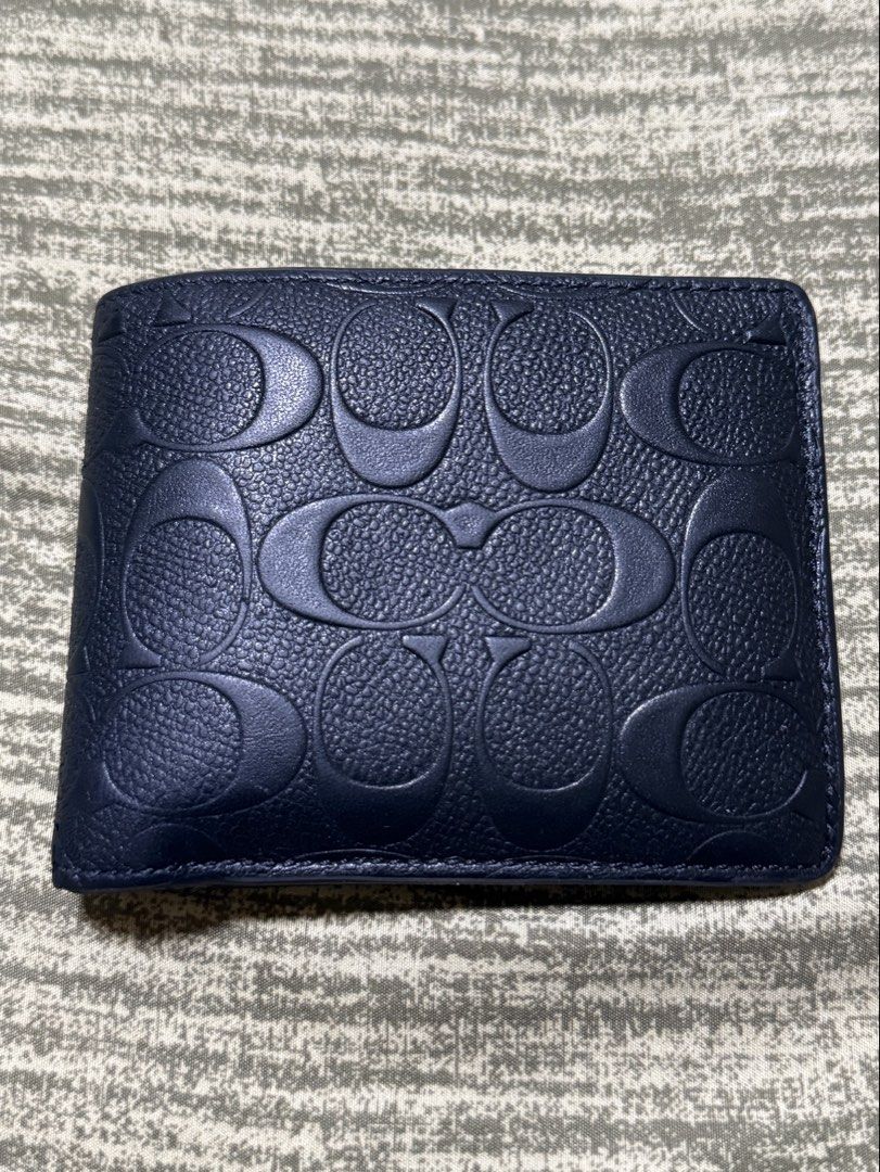 Rush! Coach Embossed Signature Bifold Wallet (Category: Luxury Bags & Wallets) located in Mandaue City. Submitted by kodenameblue (Listing ID 1443806850, Image 1). Description: - Coach Bifold Wallet - Signature embossed C logo all over exterior - Interior with multiple card slots and Bull Compartment - Unit Only no dustbag or receipt included - Clean inside and out - Issues: Signs of Wear and slight peeling at the edges (See Last Picture) RFS: Ne