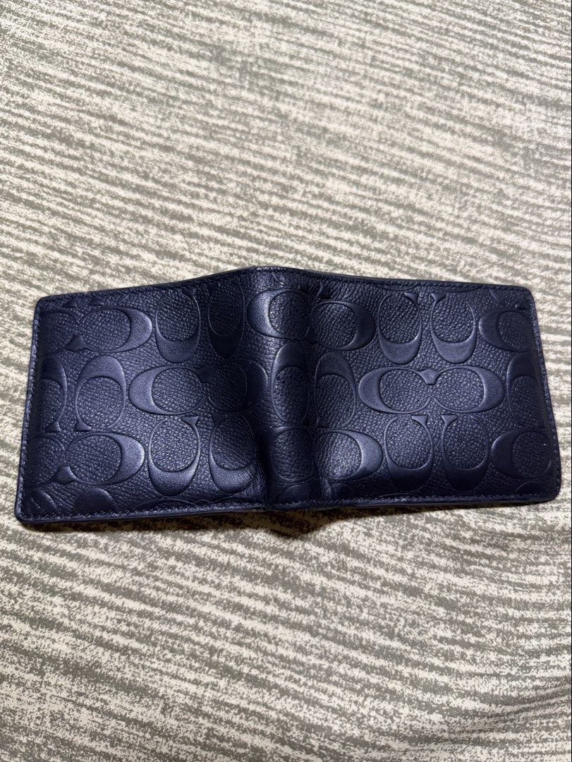 Rush! Coach Embossed Signature Bifold Wallet (Category: Luxury Bags & Wallets) located in Mandaue City. Submitted by kodenameblue (Listing ID 1443806850, Image 3). Description: - Coach Bifold Wallet - Signature embossed C logo all over exterior - Interior with multiple card slots and Bull Compartment - Unit Only no dustbag or receipt included - Clean inside and out - Issues: Signs of Wear and slight peeling at the edges (See Last Picture) RFS: Ne