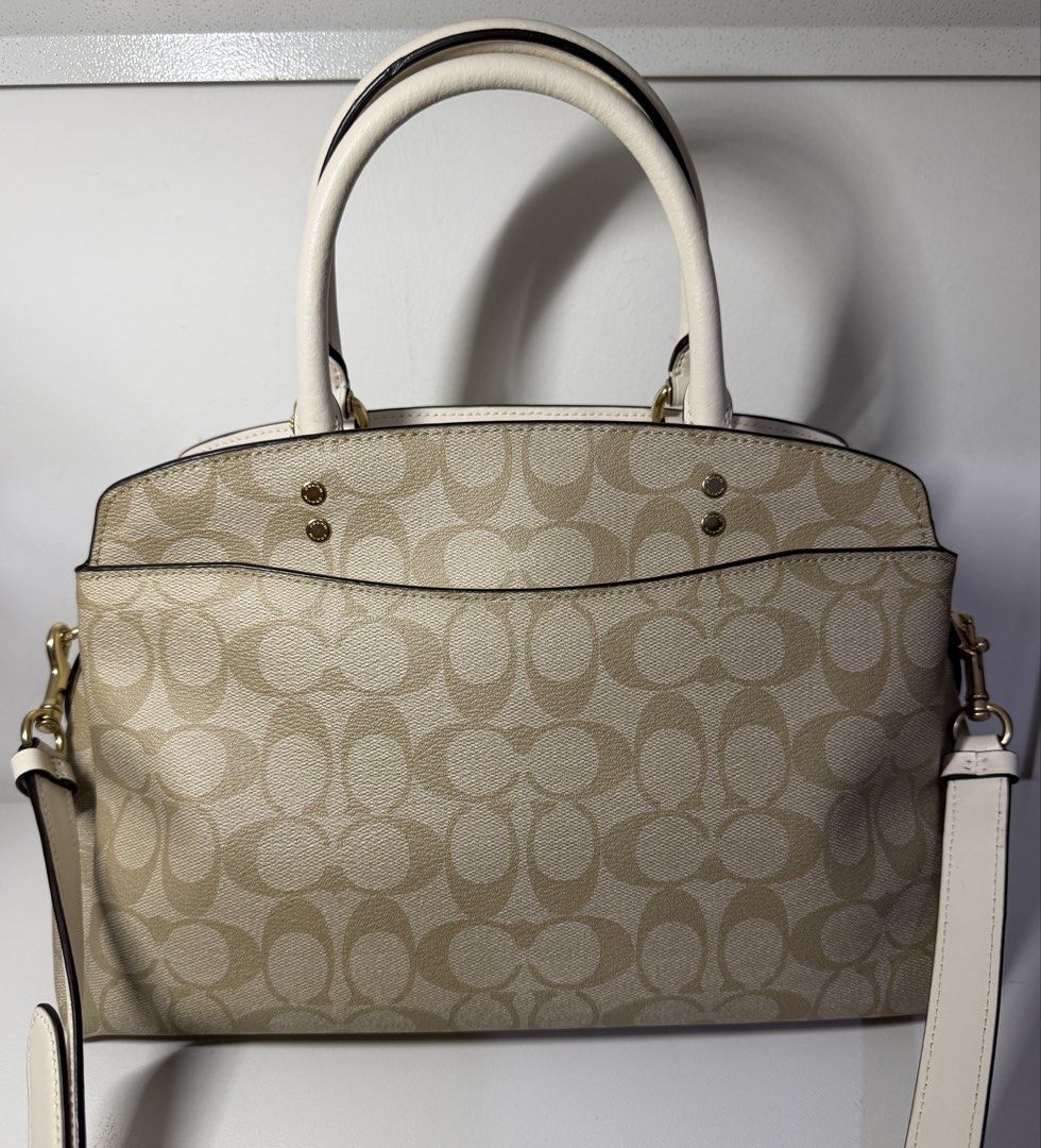 Coach Lillie Carryall Two-way Bag (Category: Luxury Bags & Wallets) located in Manila. Submitted by importgoodiesph (Listing ID 1443773513, Image 2). Description: Coach Lillie Carryall Two-way Bag - in like new condition - color: chalk - material: signature coated canvas - dimensions: 12 3/4” (L) x 8 3/4” (H) x 5 1/4” (W) - handle: 4 3/4in drop - detachable strap: 20in drop - gold tone hardwares - snap closure with fabric lining and center zip co