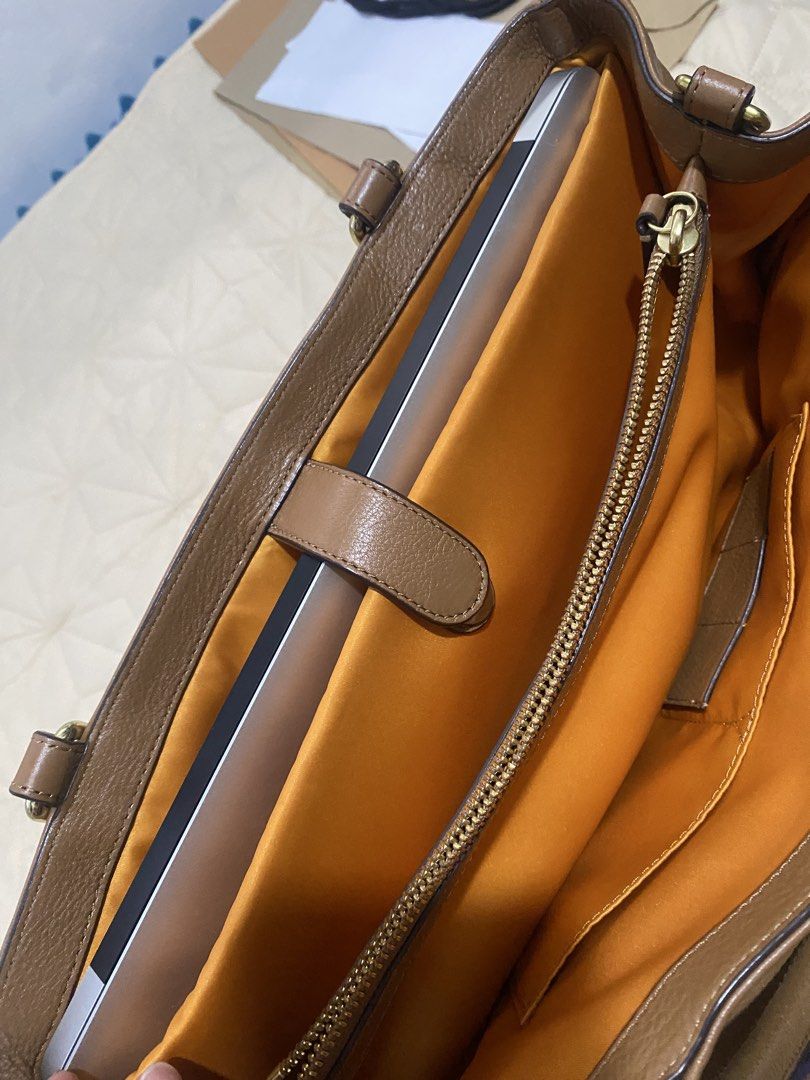 Vintage Coach Park Leather (Category: Luxury Bags & Wallets) located in Santa Rosa. Submitted by jemaustria (Listing ID 1443778761, Image 3). Description: Authentic, preloved Coach Park Leather Carryall (Style #F19728) in classic British Tan pebbled leather with gold hardware. It features a signature front turnlock pocket, spacious multi-compartment interior, and a genuine YKK interior pocket zipper. It comfortably fits a 2015 13-inch MacBook Air