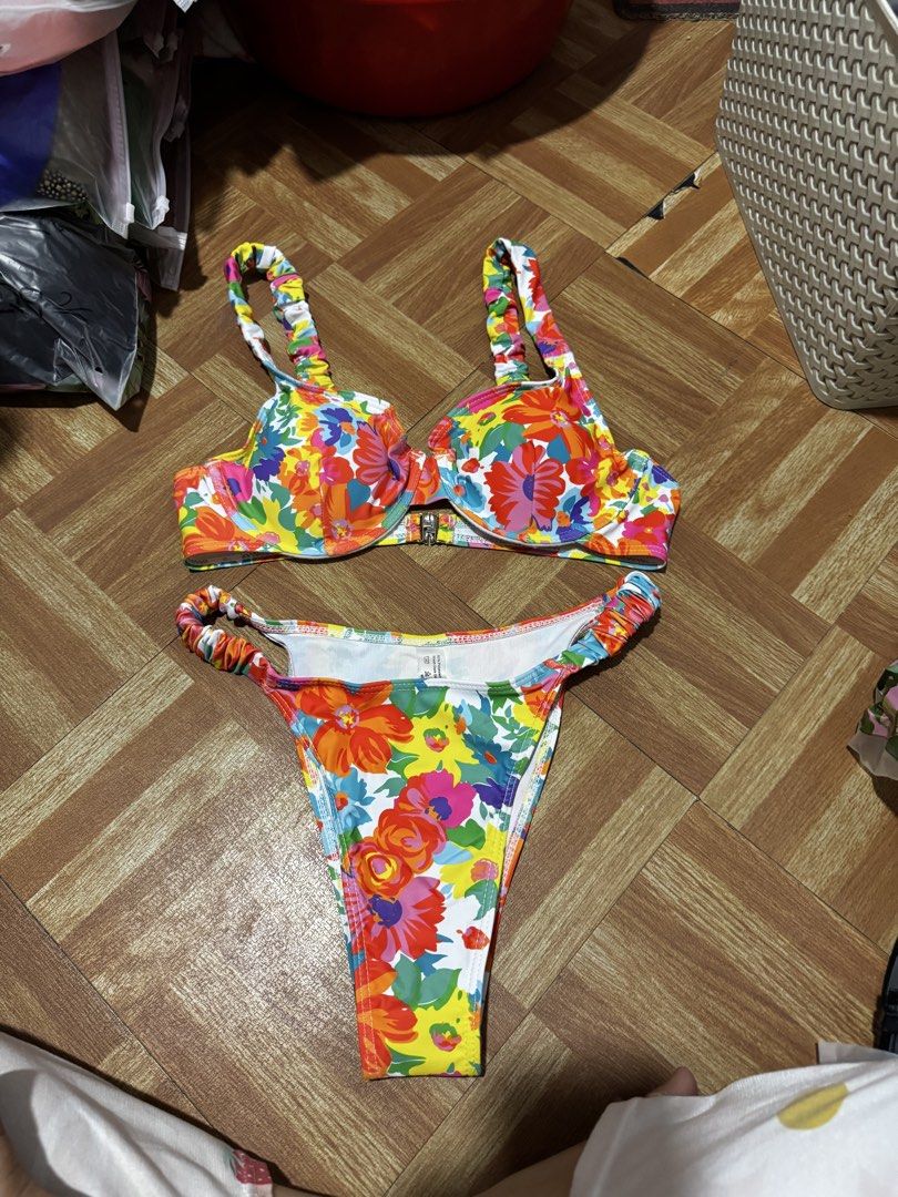 Colorful Floral Bikini Set with Ruffled Straps (Category: Bikinis & Swimsuits) located in Manila. Submitted by beaanikasc15079 (Listing ID 1443853142, Image 1). Description: - Adorable floral print bikini set in vibrant colors. - Top features underwire support and a secure clasp closure. - Both top and bottom straps have a charming ruffled detail. - High-cut bottoms for a flattering fit. - Ideal for your next beach or pool day!.
