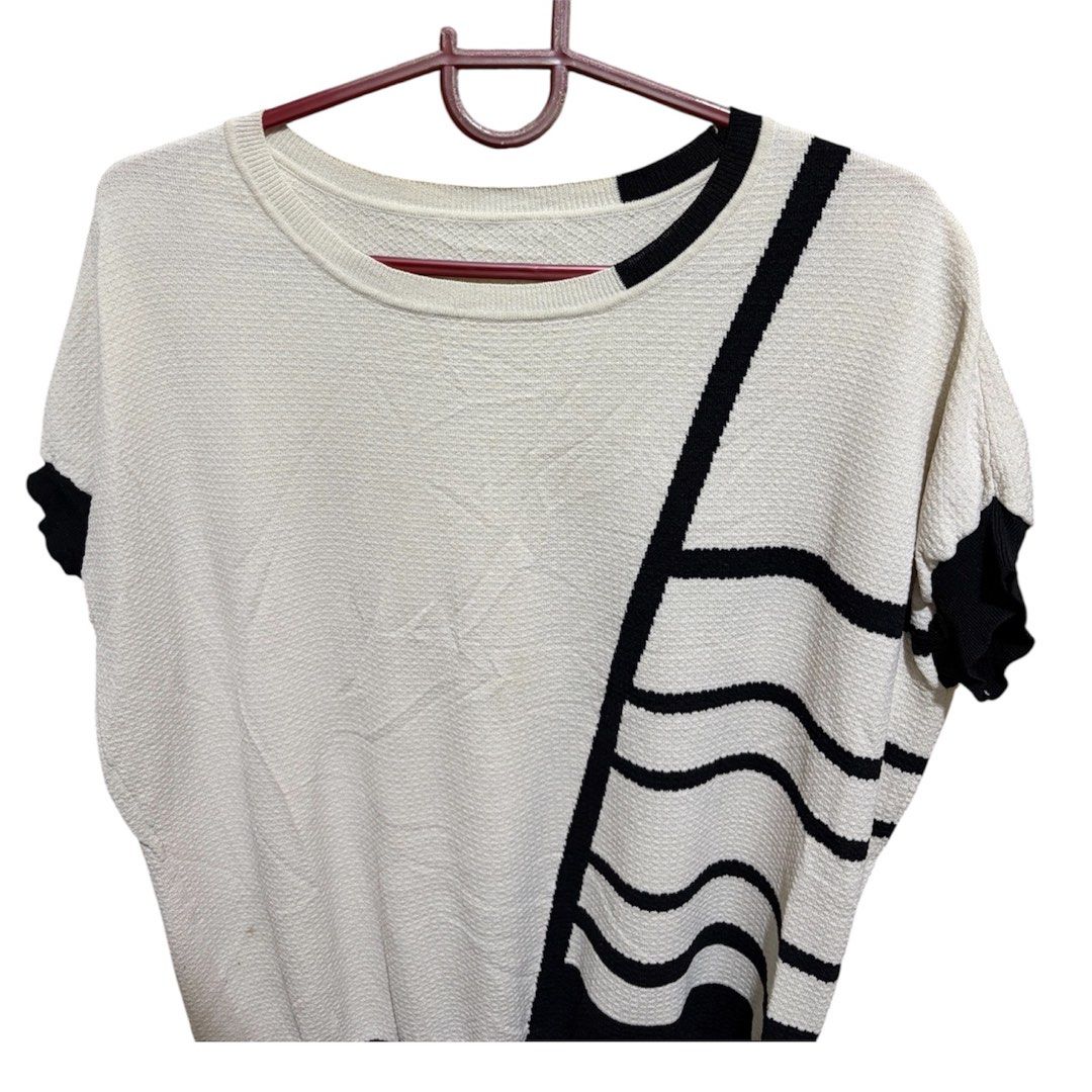 Cream-colored short sleeved Knit top (Category: Blouses) located in Quezon City. Submitted by bielle.co_09 (Listing ID 1443891519, Image 3). Description: 📌 Size runs from M-Semi XL 📌No flaws 📌 Classy design w/ bold black lines 📌Knitted top 📌 Message for more actual pics 💵MOP: Gcash Maya transfer Bank transfer (Landbank).