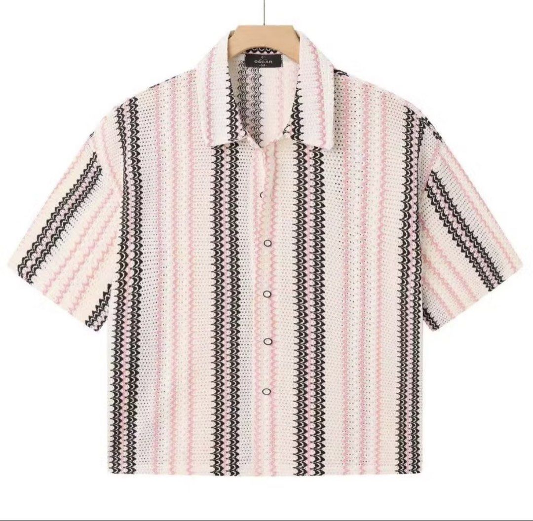 Crocheted Striped Short Sleeve Button Up Shirt (Category: Tshirts & Polo Shirts ) located in Manila. Submitted by maldimathilda (Listing ID 1443888371, Image 1). Description: - White crocheted shirt - Pink and black wavy stripes - Short sleeves - Button front closure - Relaxed fit - Ideal for casual outfits - Unique texture and pattern.