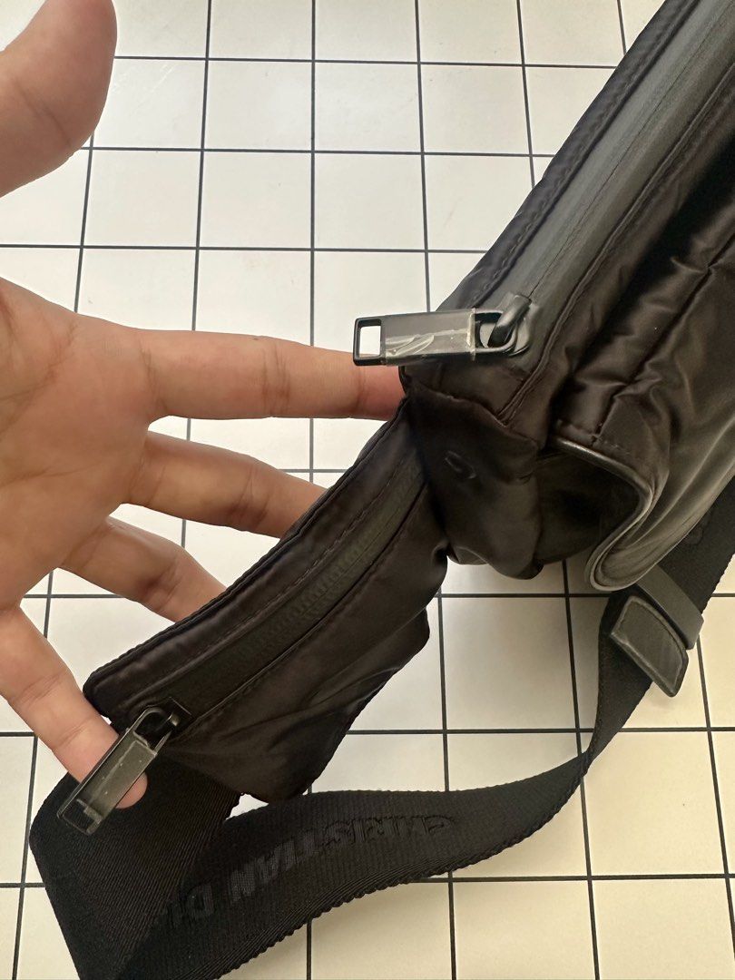 Dior Saddle Universe Belt Bag (Category: Luxury Bags & Wallets) located in Bacolod City. Submitted by puglia17 (Listing ID 1443757502, Image 2). Description: - Authentic Black Dior Waist Bag - Bought in Prague 2 years ago, used a only a few times on trips - Made from durable nylon material - Features the iconic Dior logo prominently on the front - Adjustable strap with subtle Christian Dior branding - Multiple zippered compartments for secure sto