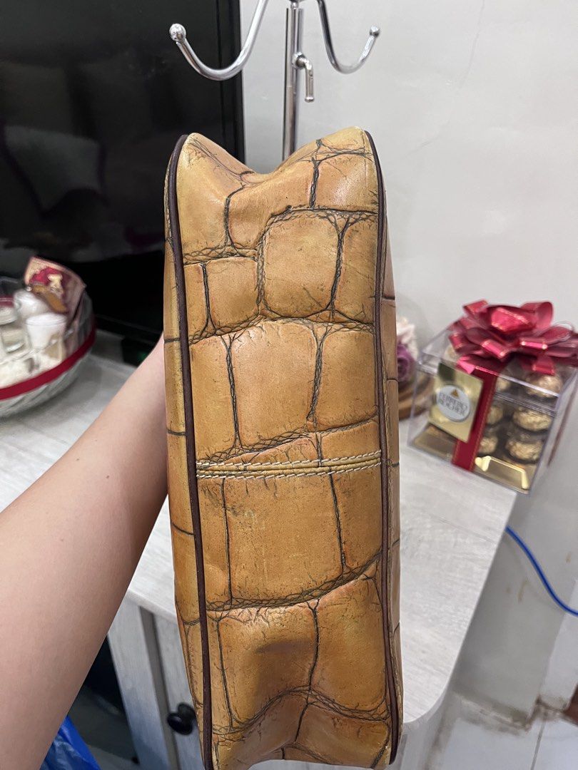 Dooney & Bourke 1975 Croc Embossed Leather Shoulder Bag (Category: Luxury Bags & Wallets) located in Quezon City. Submitted by thriftfindsphqc (Listing ID 1443706674, Image 3). Description: - Authentic Dooney & Bourke shoulder bag - Tan croc embossed leather - Silver tone hardware - Zipper closure ( Riri zipper) - Comfortable shoulder straps - Ideal for everyday use - Shows some signs of wear, but plenty of life left.