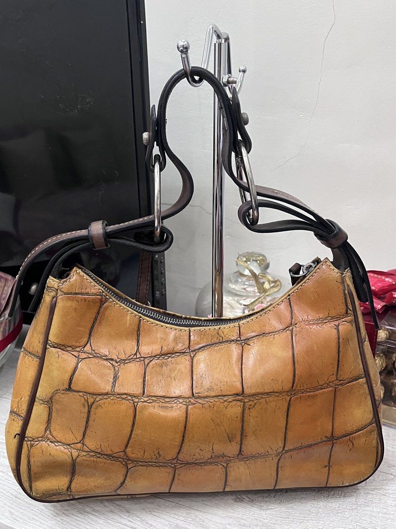 Dooney & Bourke 1975 Croc Embossed Leather Shoulder Bag (Category: Luxury Bags & Wallets) located in Quezon City. Submitted by thriftfindsphqc (Listing ID 1443706674, Image 2). Description: - Authentic Dooney & Bourke shoulder bag - Tan croc embossed leather - Silver tone hardware - Zipper closure ( Riri zipper) - Comfortable shoulder straps - Ideal for everyday use - Shows some signs of wear, but plenty of life left.