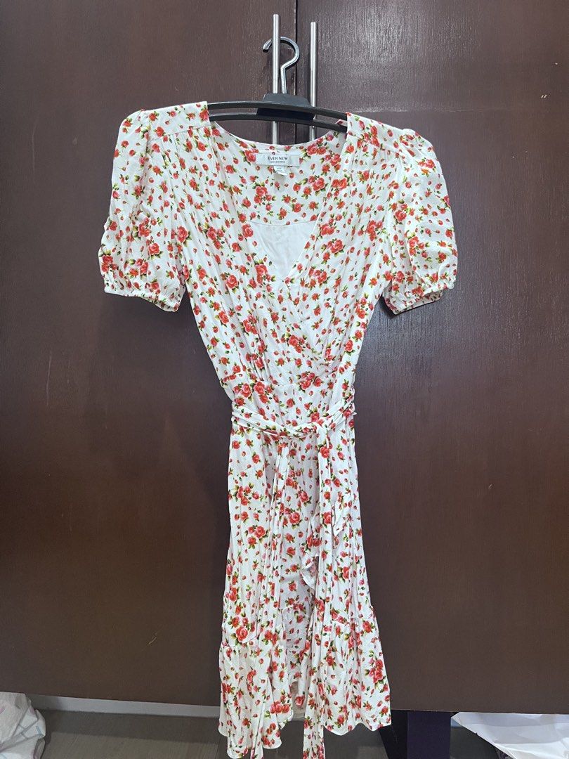 Ever New Floral Wrap Dress (Category: Dresses) located in Rizal. Submitted by mariepacis (Listing ID 1443764746, Image 2). Description: Chic white dress with a red floral print. Features short puff sleeves, a V-neck wrap front, and a ruffled hem. Includes a tie belt. Perfect for casual days!.